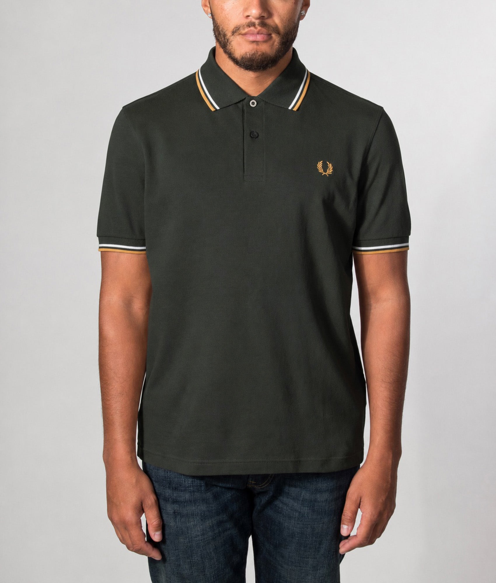 Fred Perry Twin Tipped Polo Shirt in Night Green, Dusky Blue and Dark Caramel at EQVVS Menswear. Model front shot.