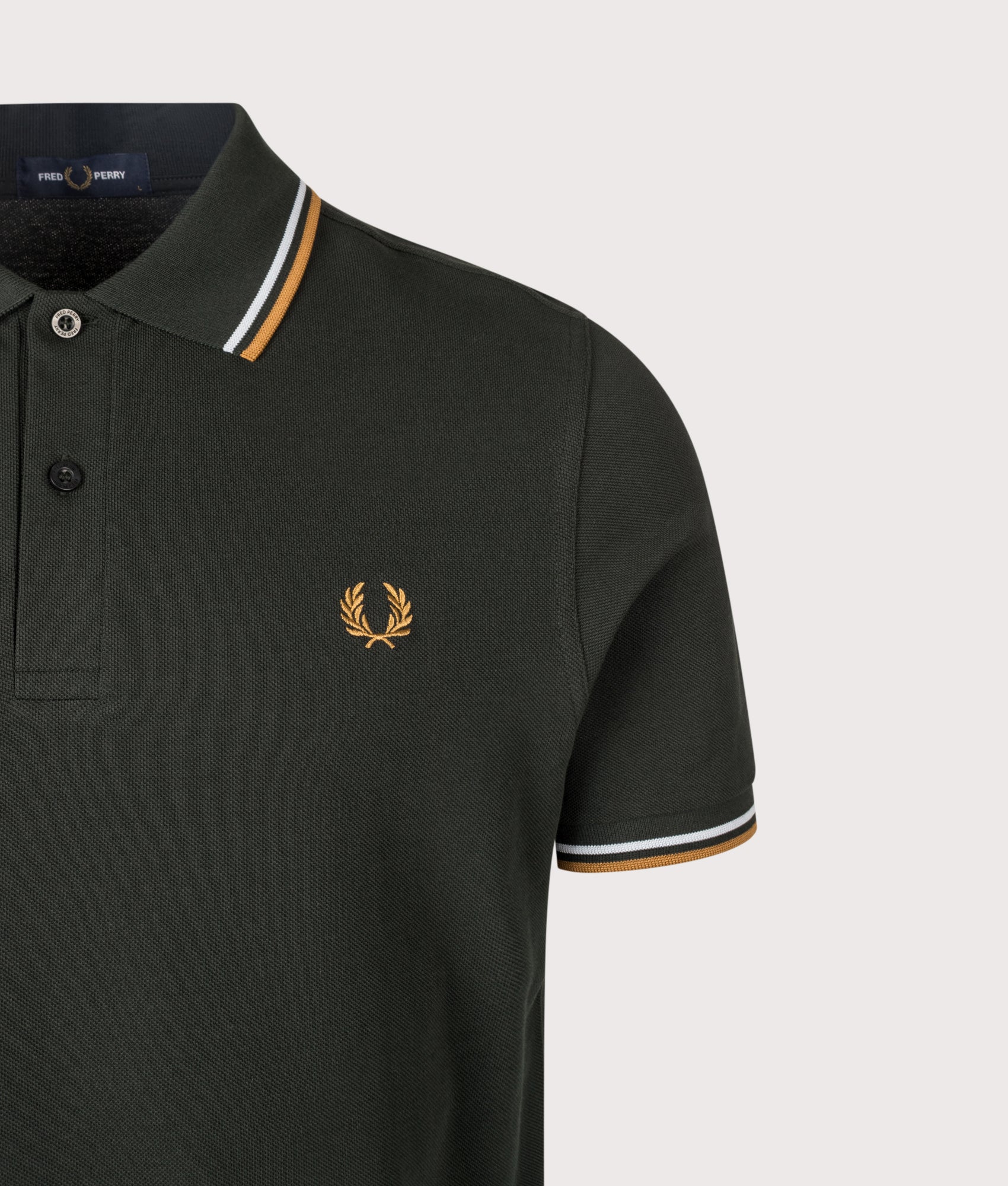 Fred Perry Twin Tipped Polo Shirt in Night Green, Dusky Blue and Dark Caramel at EQVVS Menswear. Detail shot.