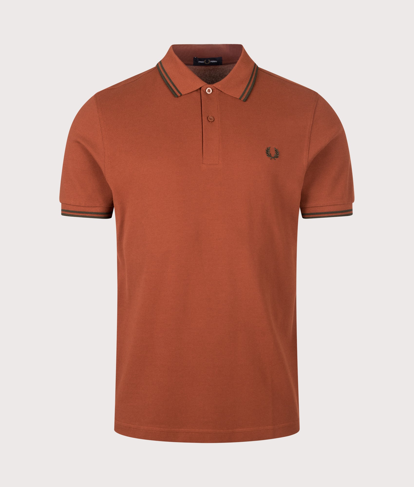Fred Perry Twin Tipped Polo Shirt in  Brandy and Night Green at EQVVS Menswear. Front shot.