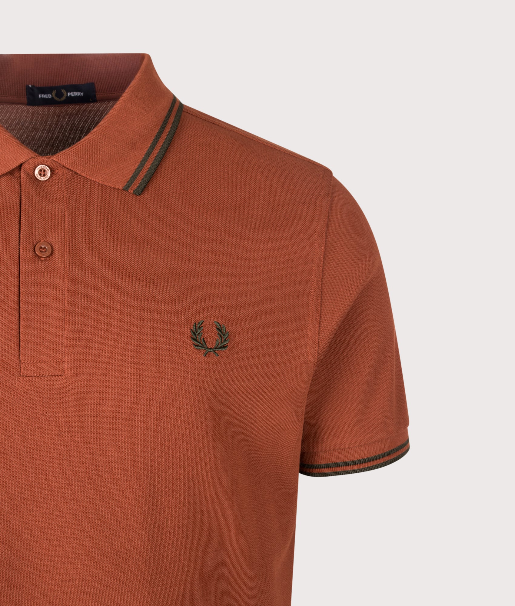 Fred Perry Twin Tipped Polo Shirt in  Brandy and Night Green at EQVVS Menswear. Detail shot.
