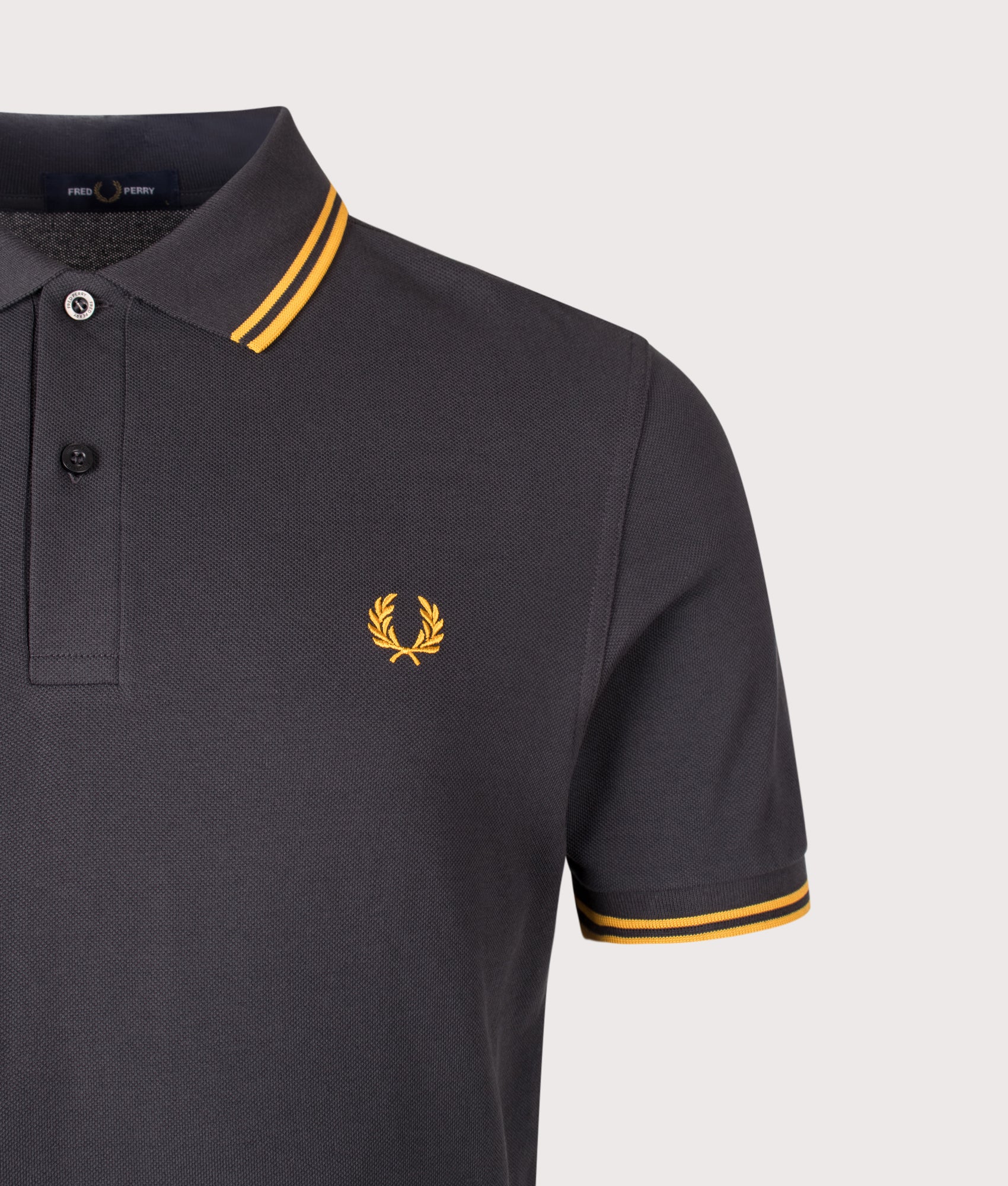 Fred Perry Twin Tipped Polo Shirt in Anchor Grey and Golden colourway. Detail shot.