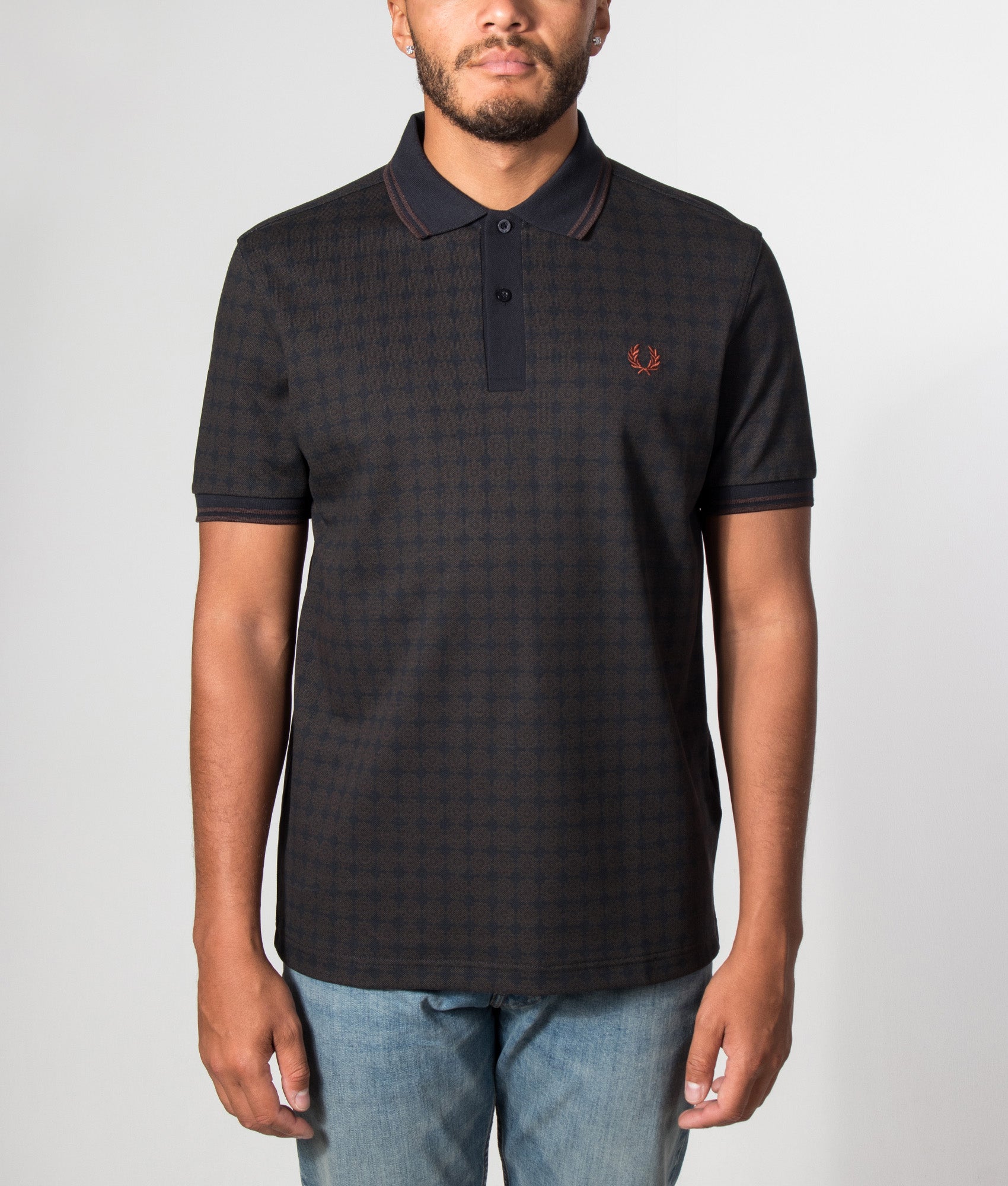 Fred Perry Regular Fit Floral Print Polo Shirt in Navy at EQVVS Menswear. Model front shot.