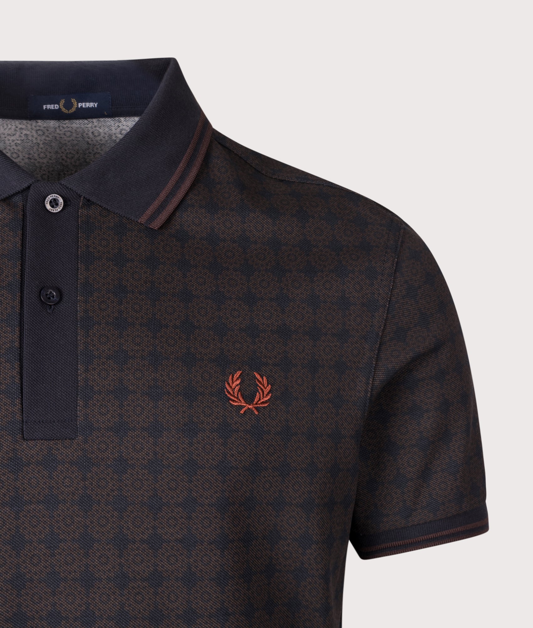 Fred Perry Regular Fit Floral Print Polo Shirt in Navy at EQVVS Menswear. Detail shot.