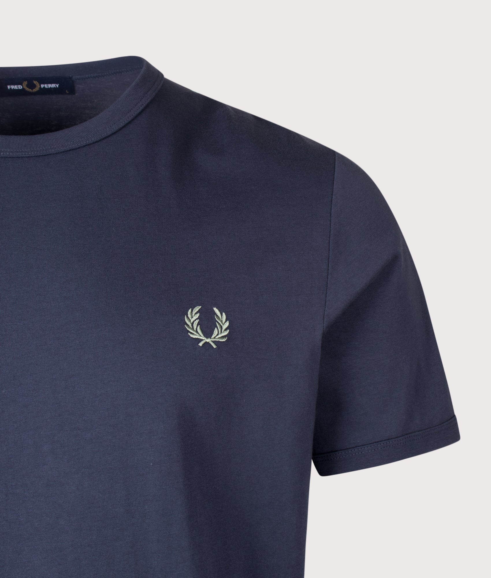 Fred Perry Regular Fit Ringer T-Shirt in Dark Airforce at EQVVS Menswear. Detail shot.