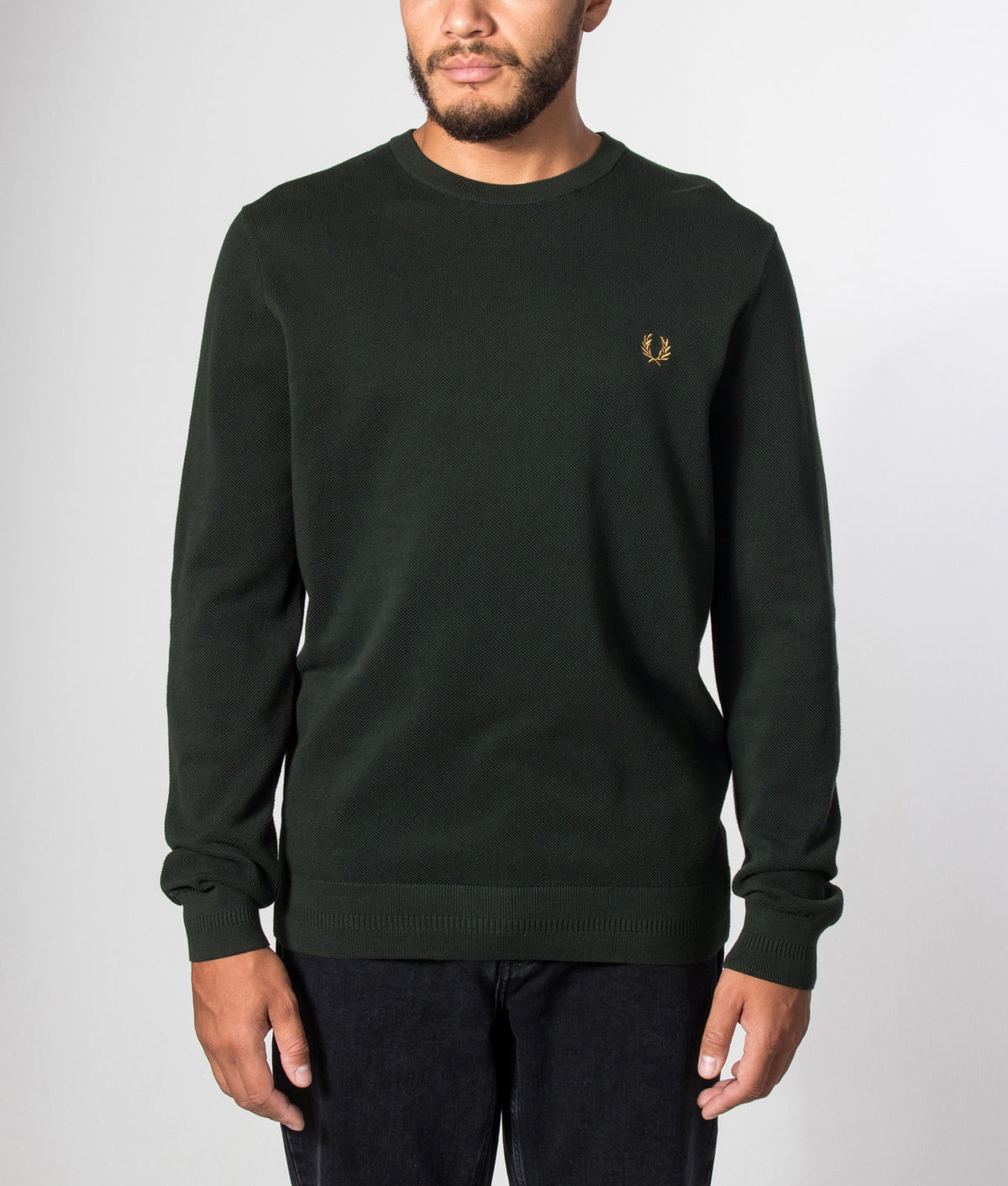 Fred Perry Regular Fit Piqué Stitch Jumper in Night Green at EQVVS Menswear. Model front shot.