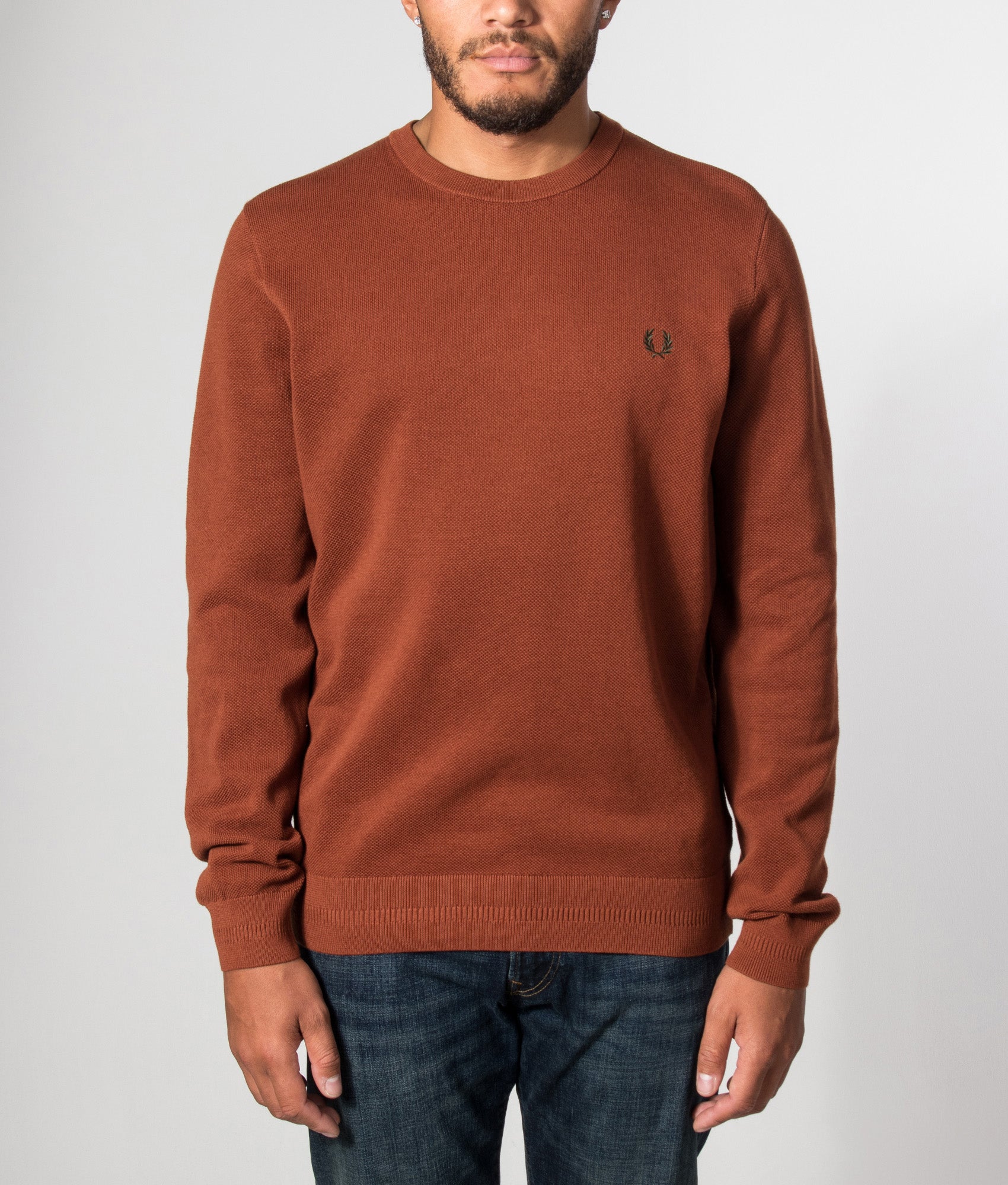 Fred Perry Regular Fit Piqué Stitch Jumper in Brandy at EQVVS Menswear. Model front shot.