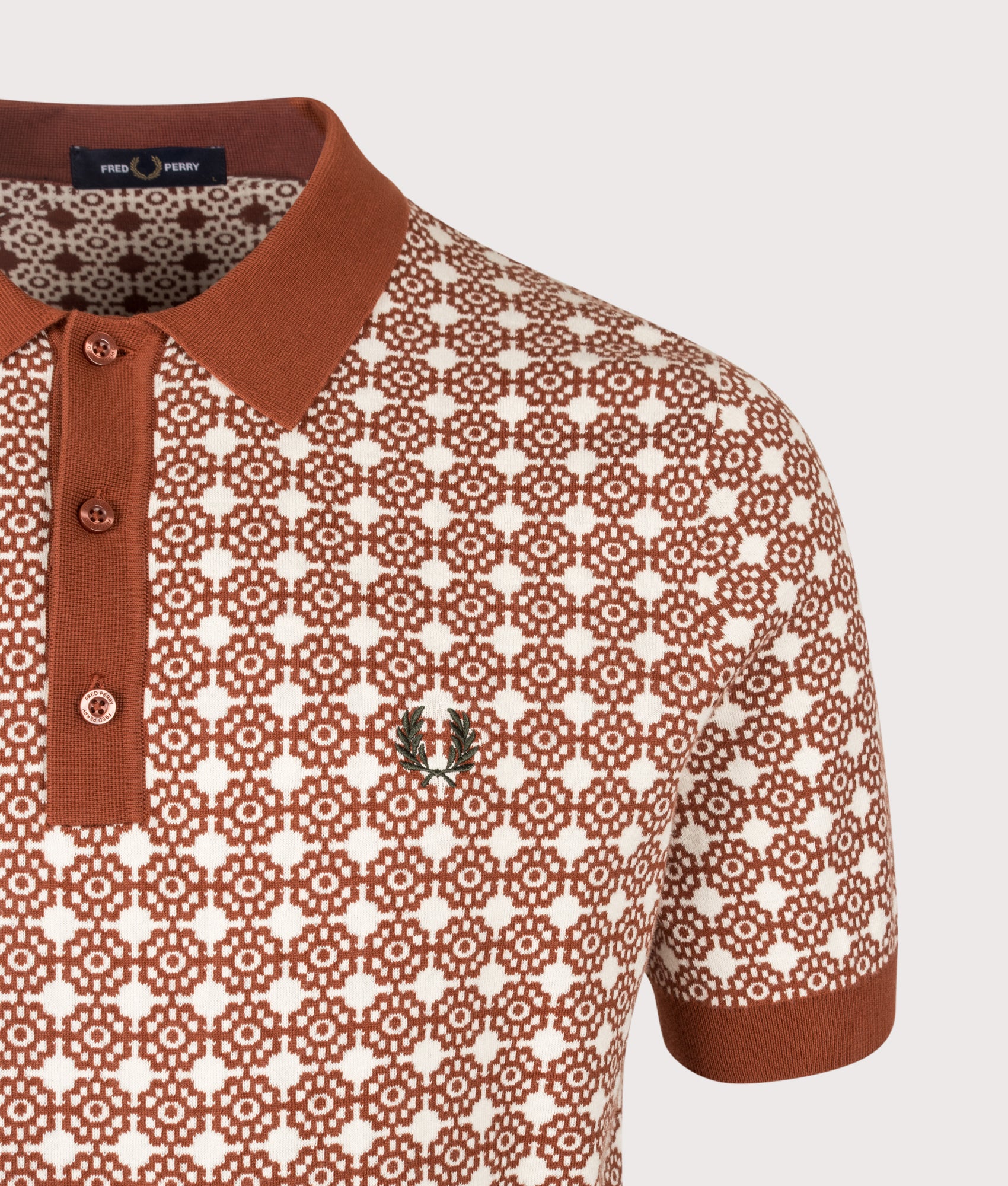 Fred Perry Regular Fit Floral Jacquard Polo Shirt in Brandy at EQVVS Menswear. Detail shot.