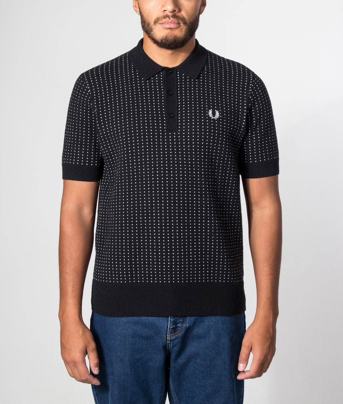 Fred Perry Regular Fit Bouclé Dot Knitted Polo Shirt in Black at EQVVS Menswear. Model front shot.