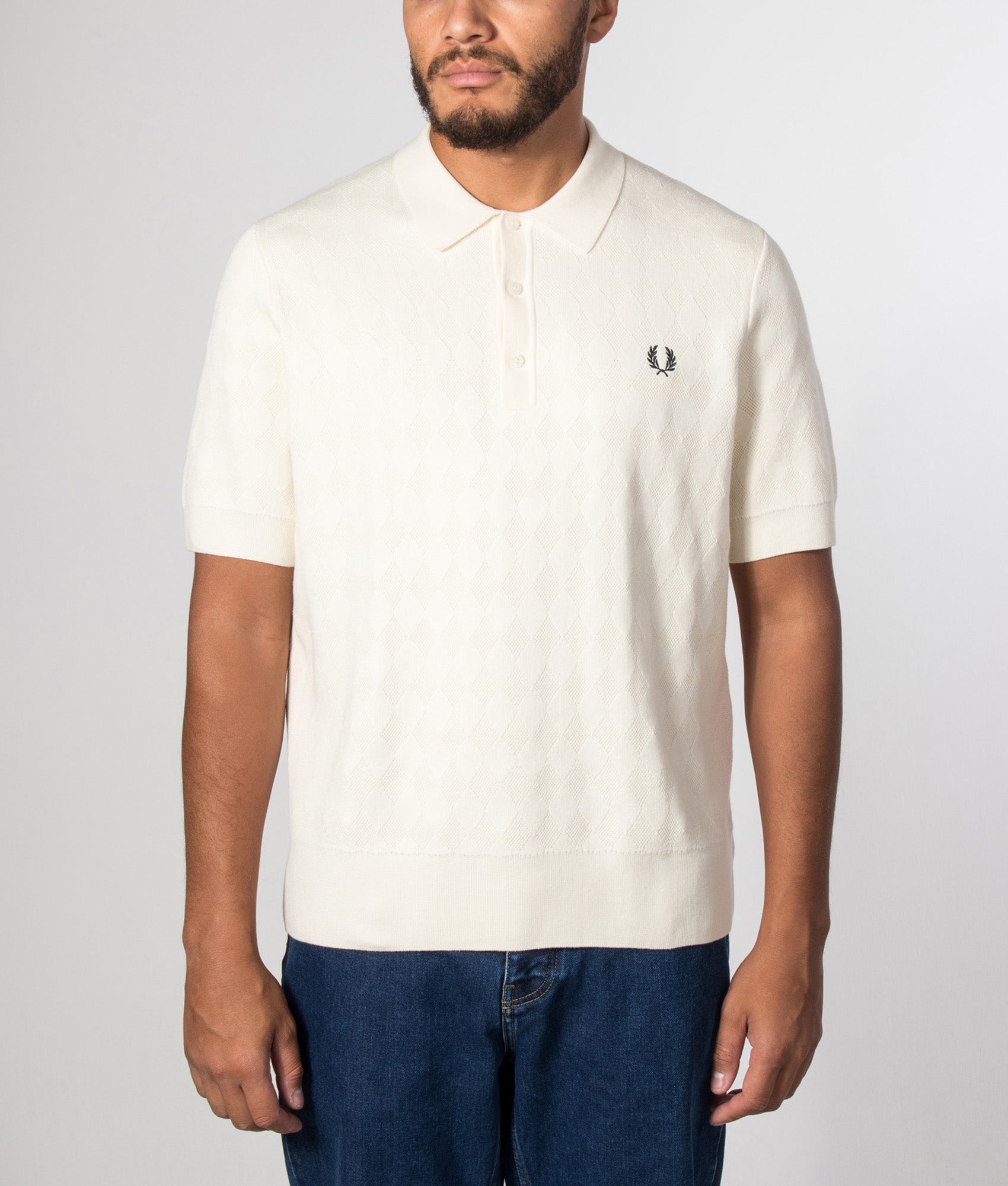 Fred Perry Regular Fit Pointelle Knitted Polo Shirt in Ecru at EQVVS menswear. Model front shot.