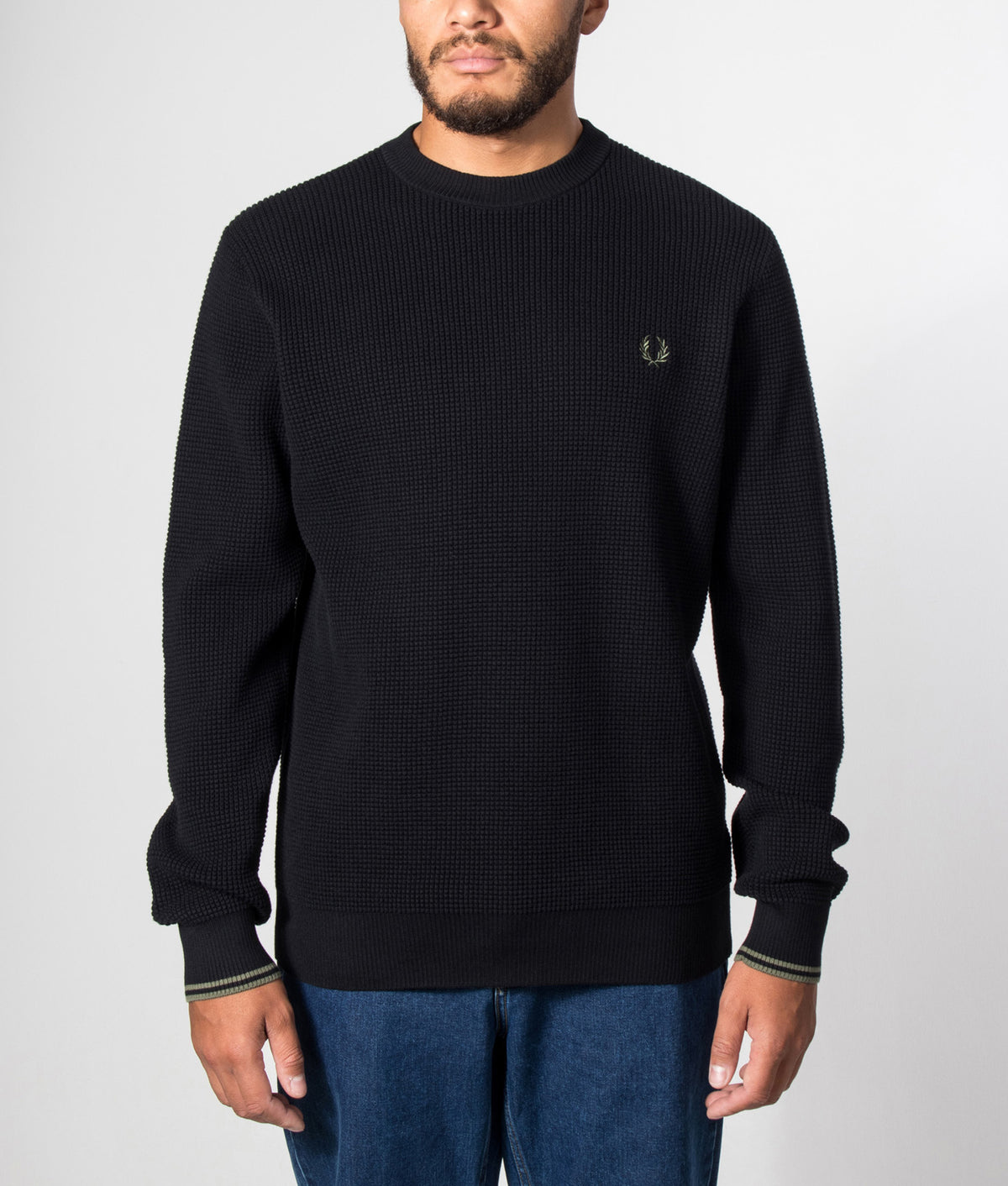 Fred Perry Regular Fit Waffle Stitch Jumper in Black at EQVVS Menswear. Model front shot.