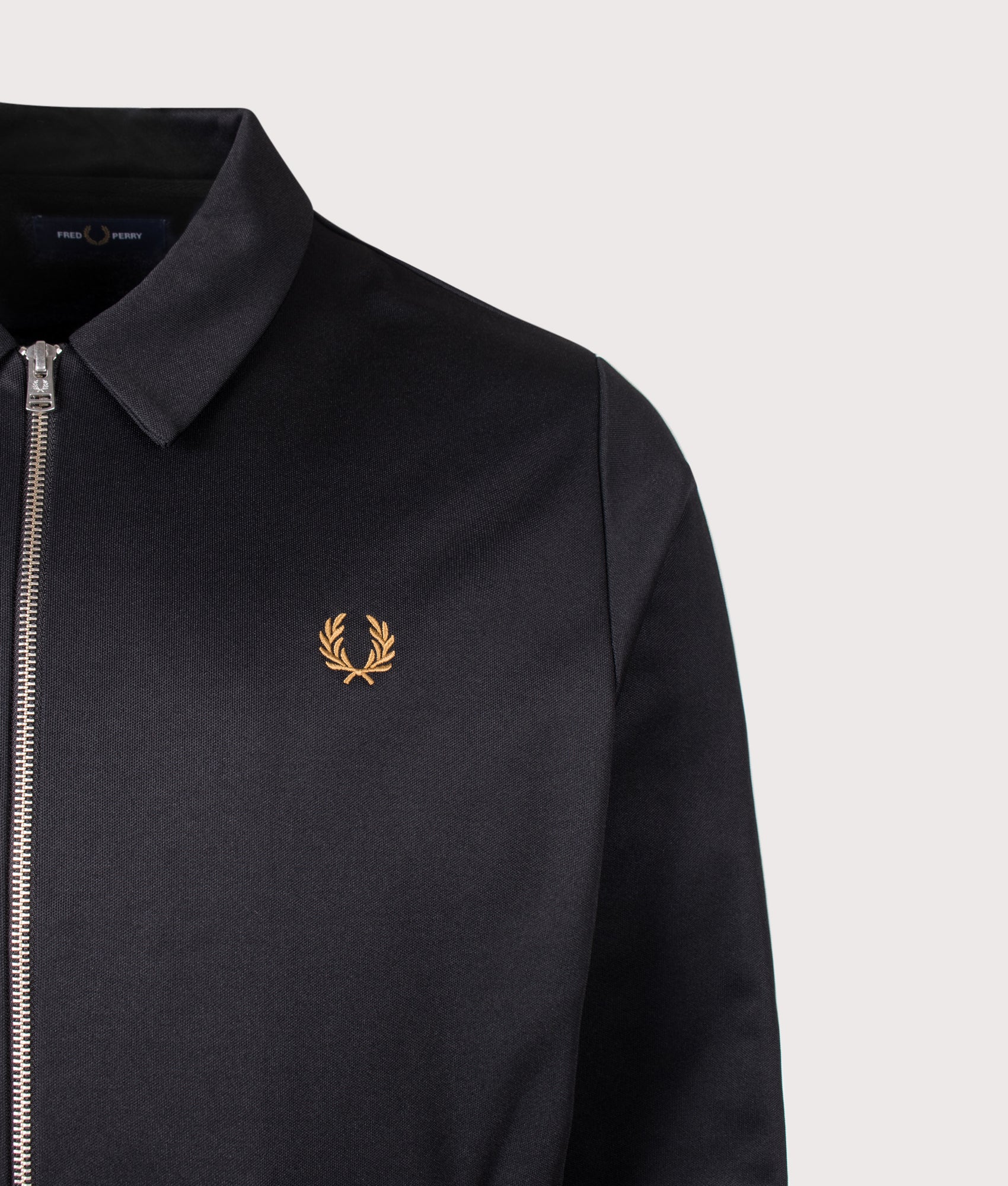 Fred Perry Regular Fit Tipped Tape Track Jacket in Black at EQVVS Menswear. Detail shot.