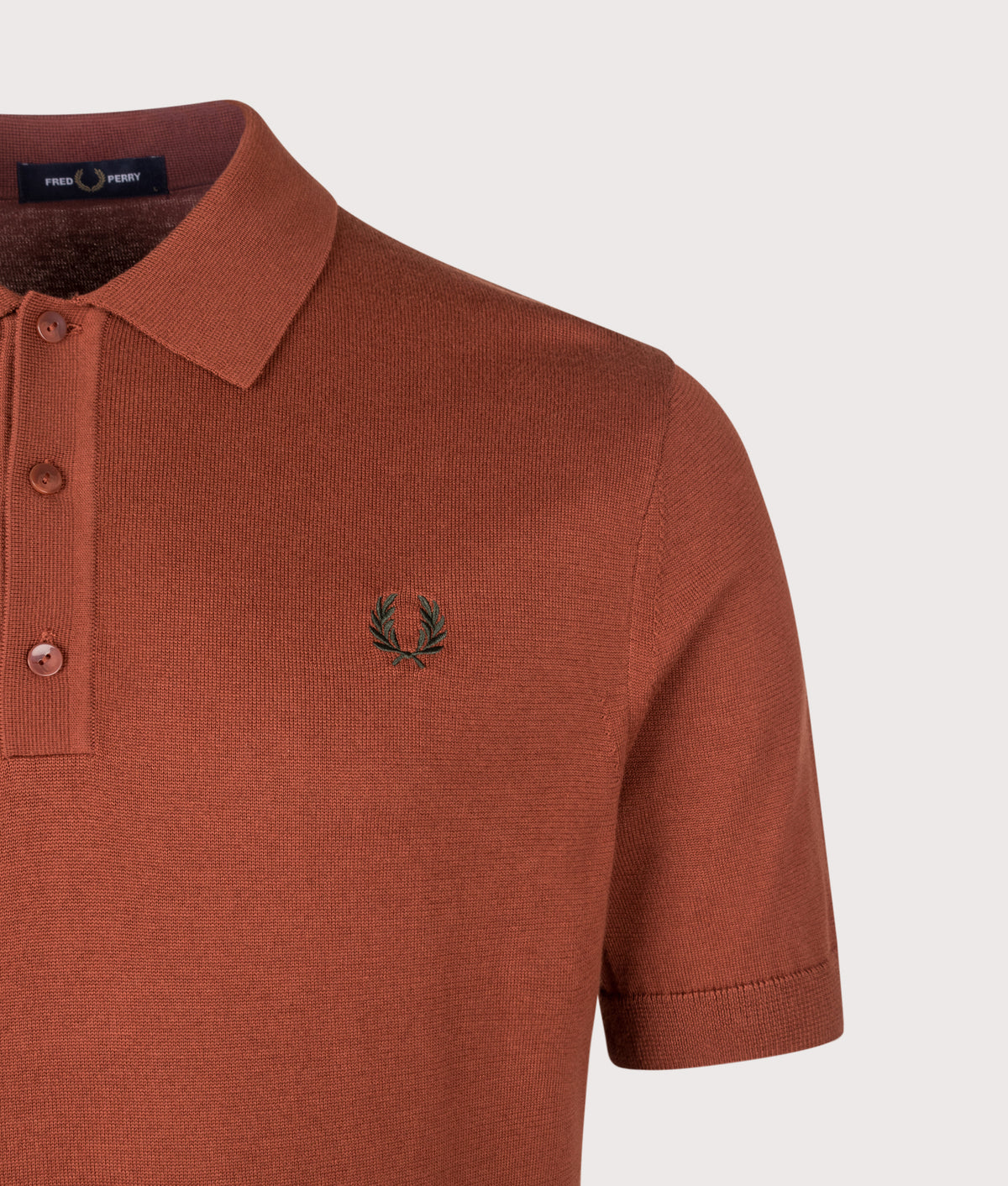 Fred Perry Regular Fit Supima Cotton Knitted Polo Shirt in Brandy at EQVVS Menswear. Detail shot.