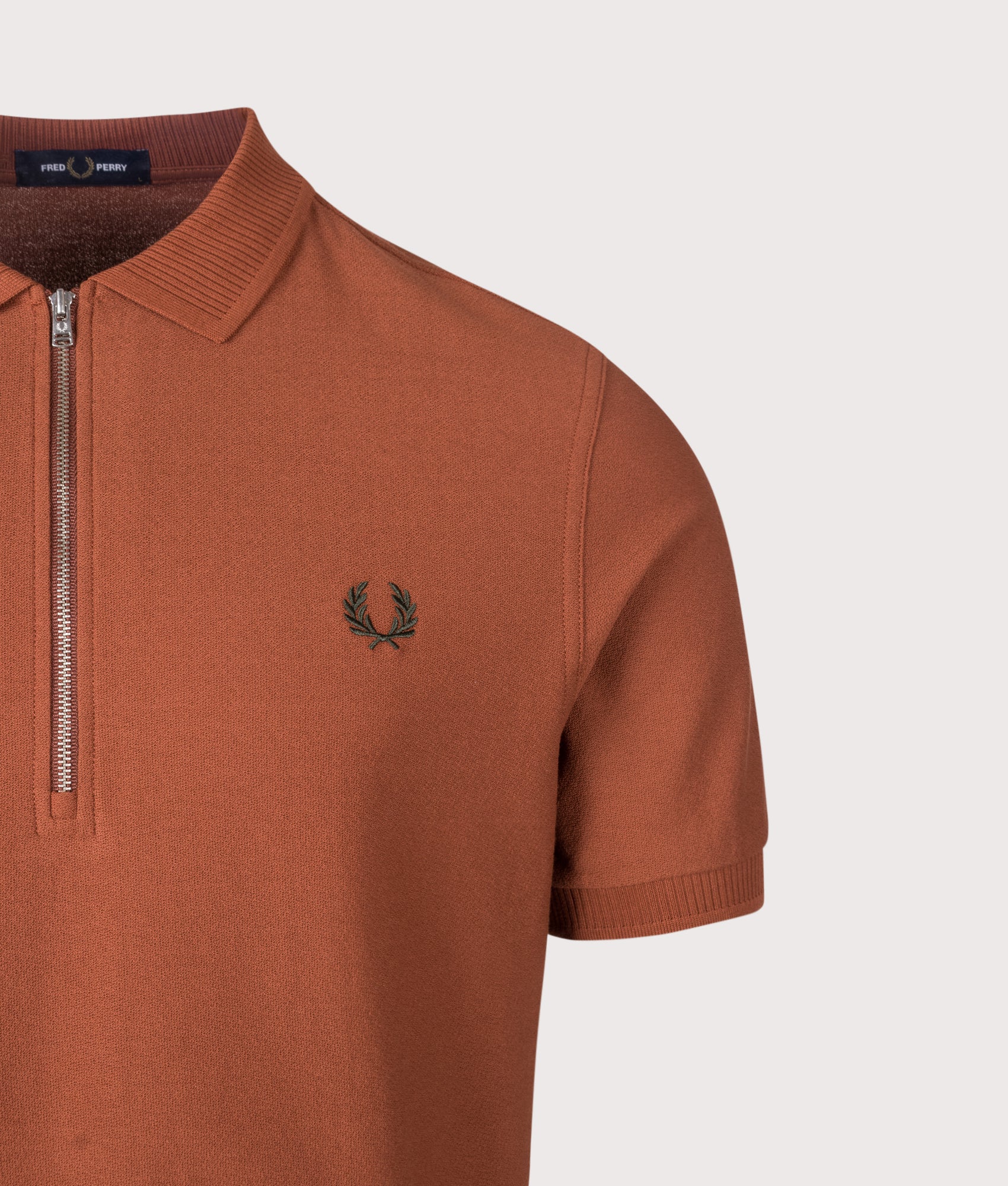 Fred Perry Regular Fit Crepe Piqué Polo Shirt in Brandy at EQVVS Menswear. Detail shot.