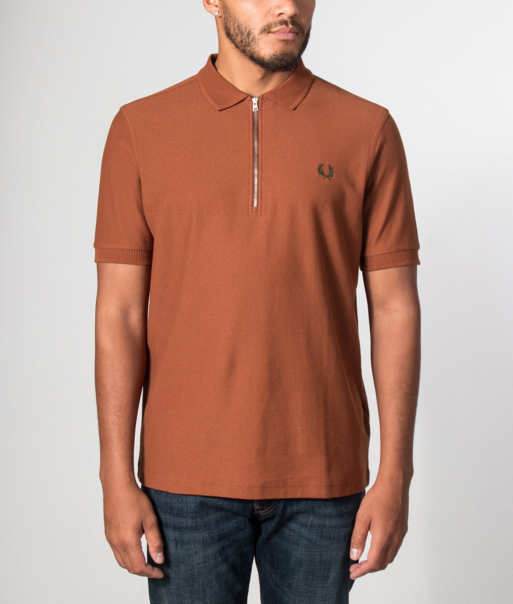 Fred Perry Regular Fit Crepe Piqué Polo Shirt in Brandy at EQVVS Menswear. Model front shot.