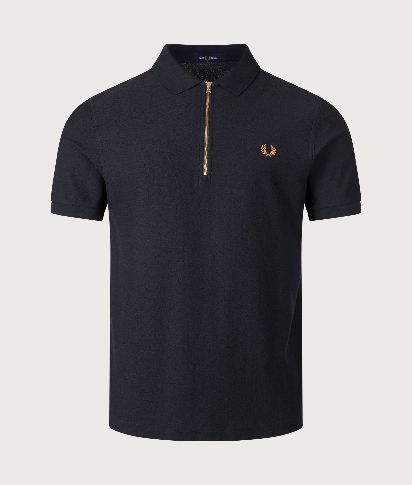 Fred Perry Regular Fit Zip Neck Tipped Tape Polo Shirt in Black at EQVVS Menswear. Front shot.