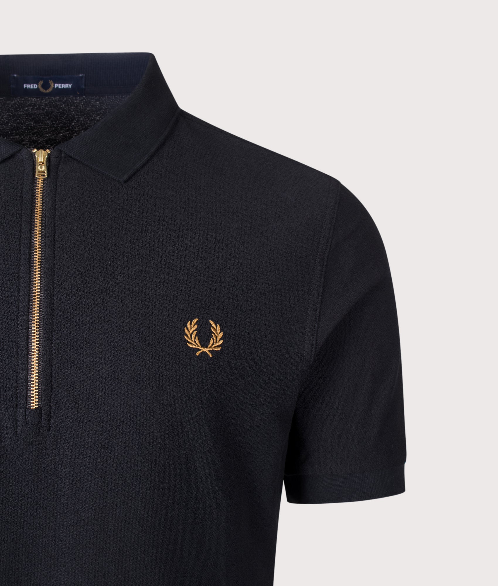 Fred Perry Regular Fit Zip Neck Tipped Tape Polo Shirt in Black at EQVVS Menswear. Detail shot.