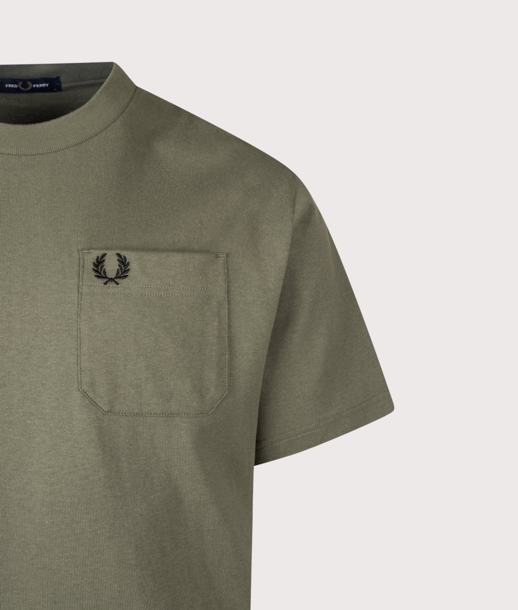 Fred Perry Relaxed Fit T-Shirt in Laurel Wreath Green at EQVVS Menswear. Detail shot.