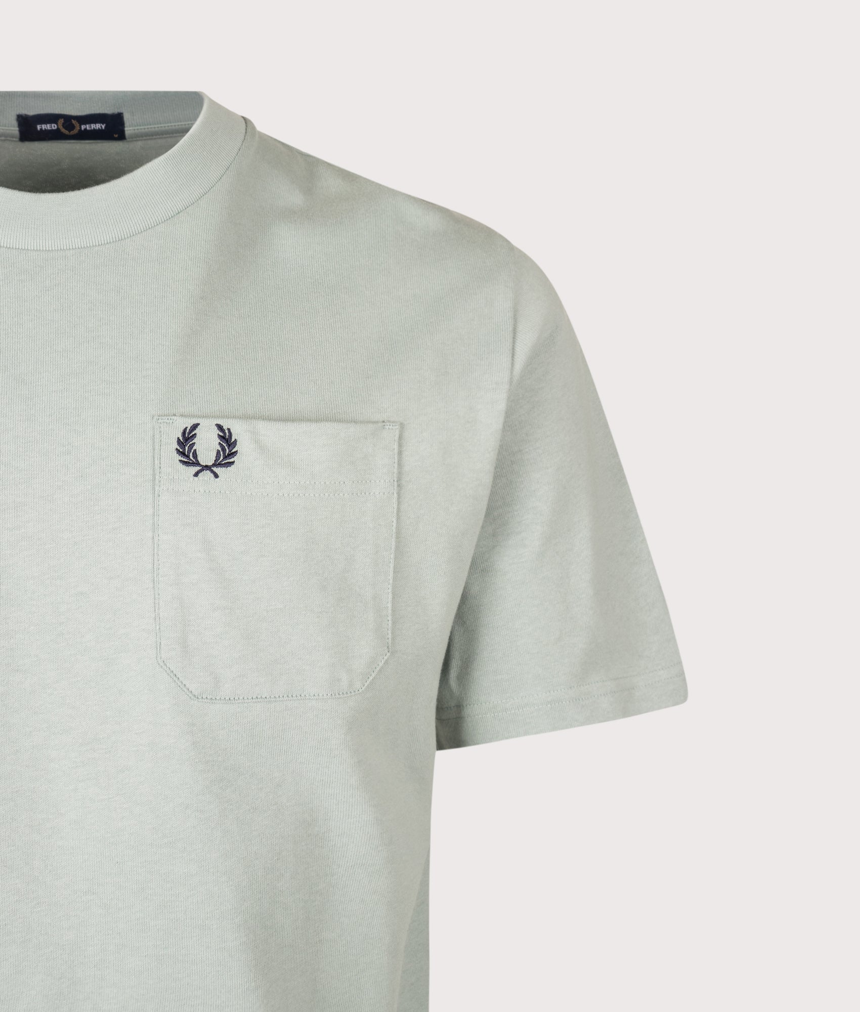 Fred Perry Relaxed Fit T-Shirt in Silver Blue at EQVVS Menswear. Detail shot.