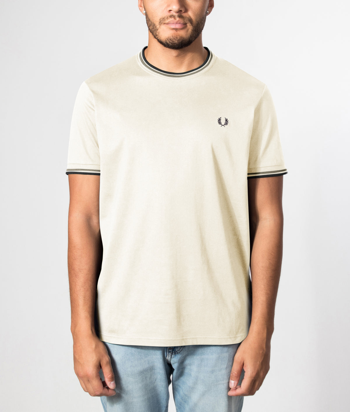 Fred Perry look, the Twin Tipped T-Shirt in Ecru, Seagrass and Dark Airforce at EQVVS Menswear. Front model shot.