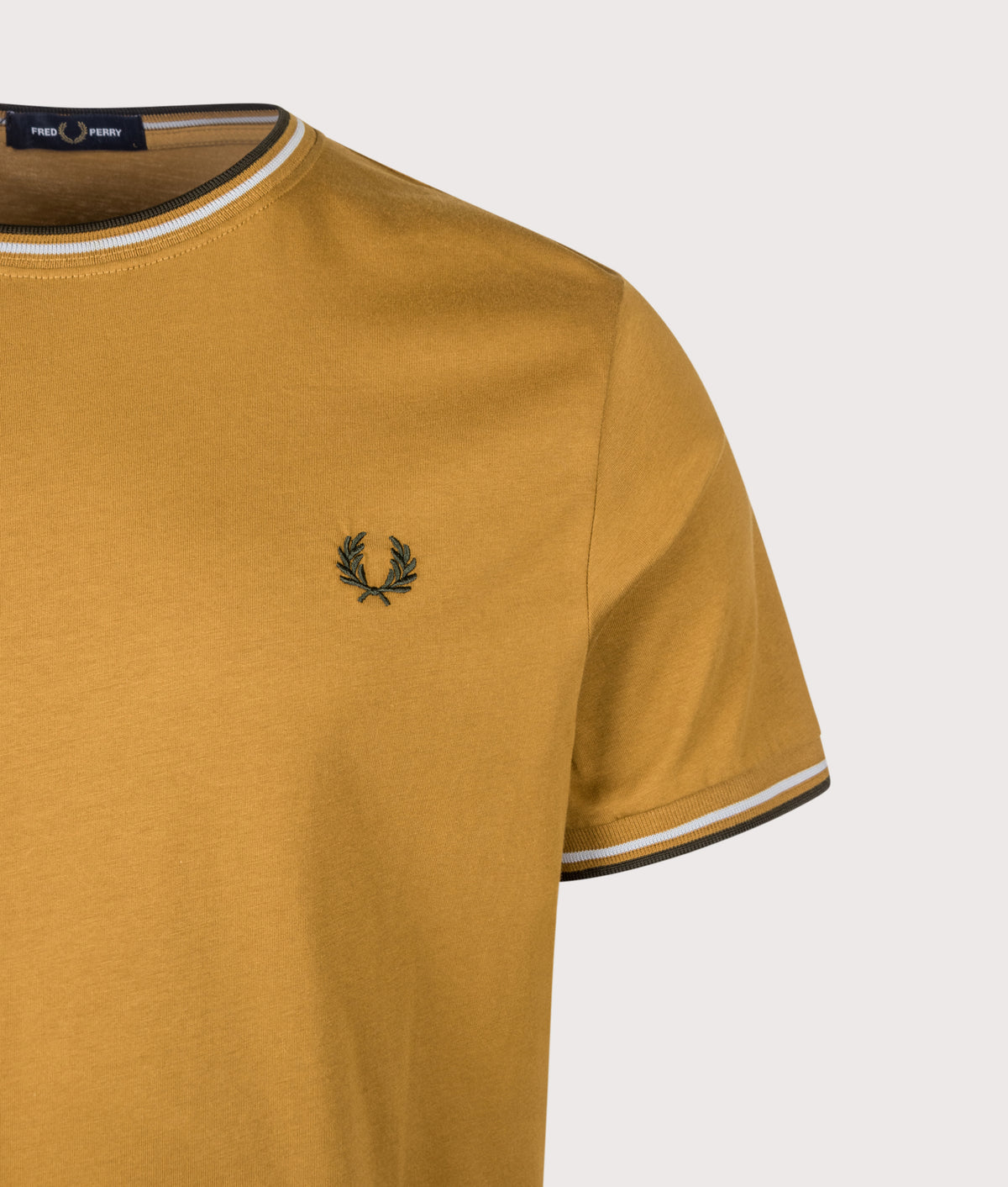 Fred Perry Regular Fit Twin Tipped T-Shirt in Dark Caramel, Dusky Blue and Night Green at EQVVS Menswear. Detail shot.