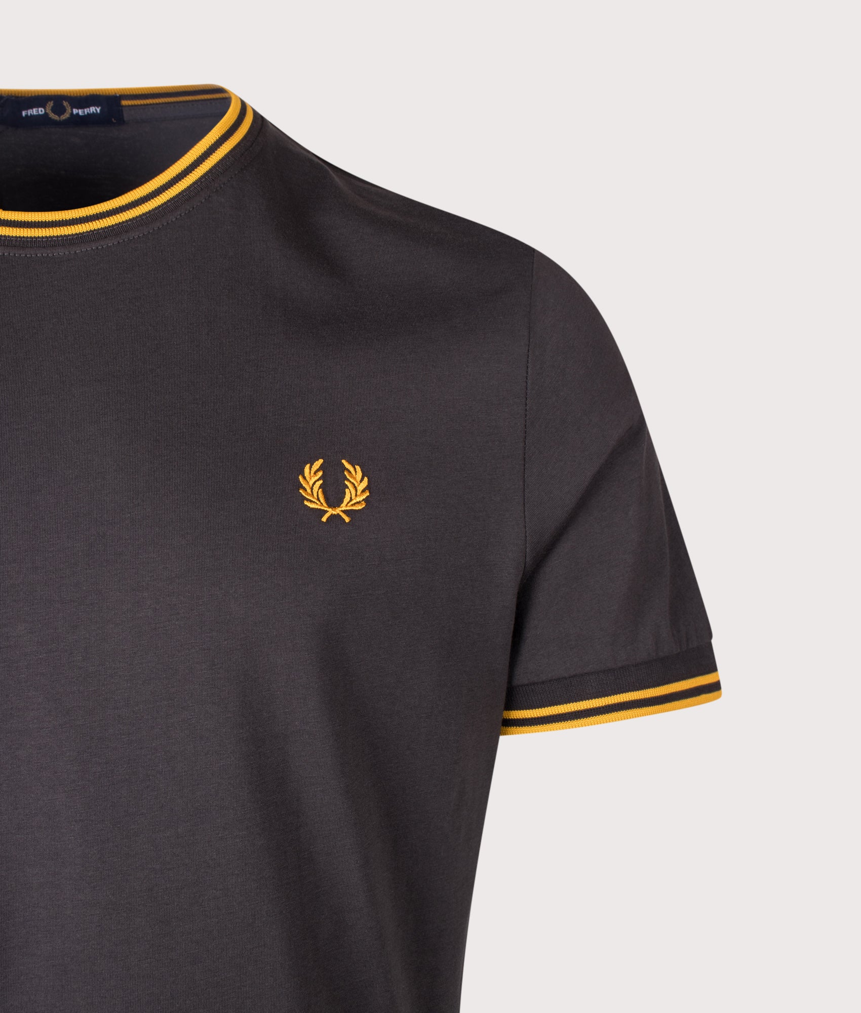 Fred Perry Regular Fit Twin Tipped T-Shirt in Anchor Grey and Golden at EQVVS Menswear. Back shot.