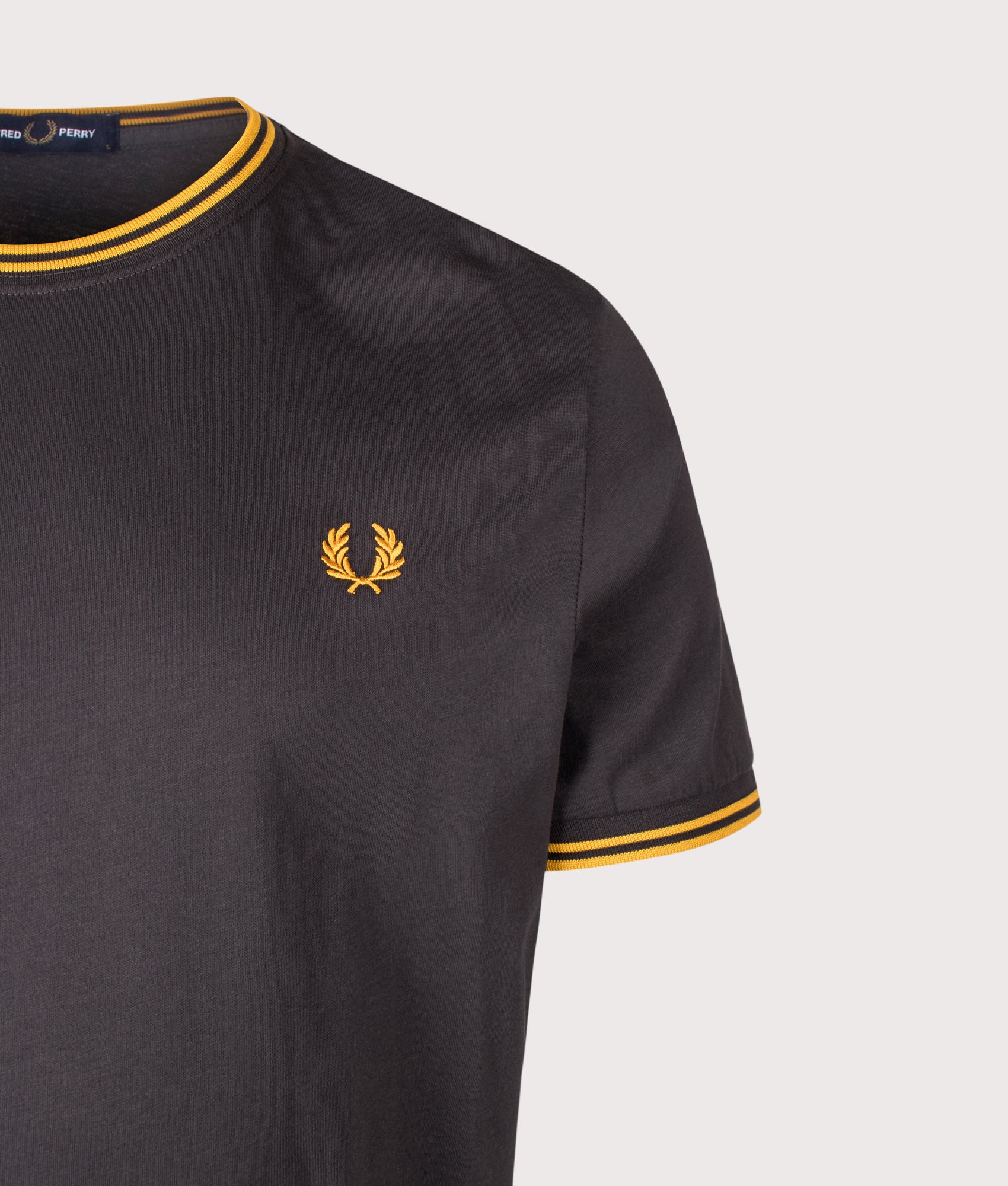 Fred Perry Regular Fit Twin Tipped T-Shirt in Anchor Grey and Golden at EQVVS Menswear. Detail shot.