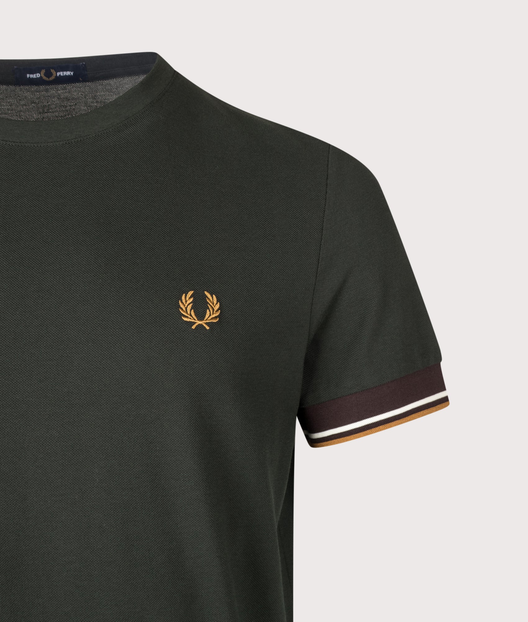 Fred Perry Regular Fit Twin Tipped Cuff T-Shirt in Night Green at EQVVS Menswear. Detail shot.