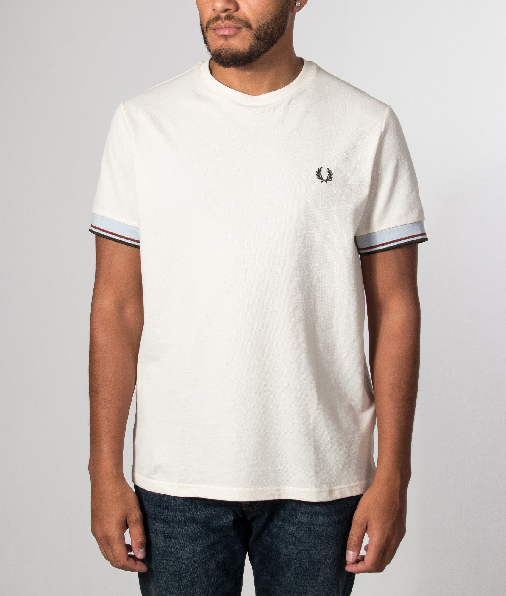 Fred Perry Regular Fit Twin Tipped Cuff T-Shirt in Ecru at EQVVS Menswear. Model front shot.