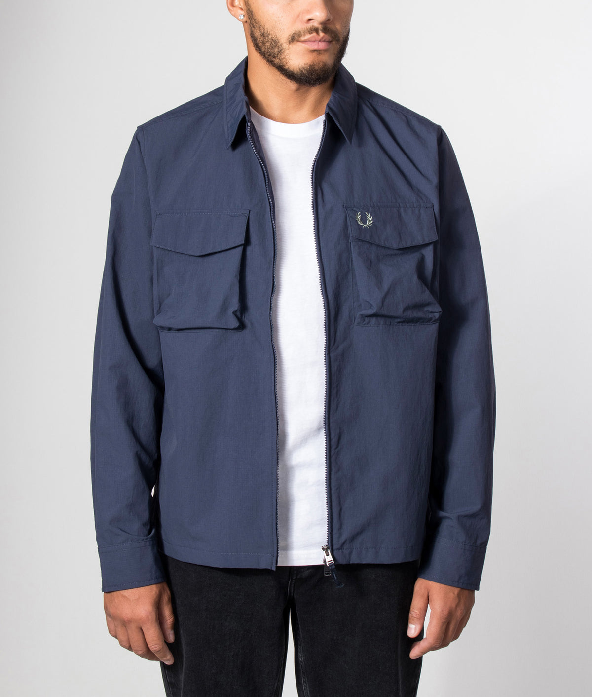 Fred Perry Ripstop Pocket Overshirt in Dark Airforce at EQVVS Menswear. Model front shot.