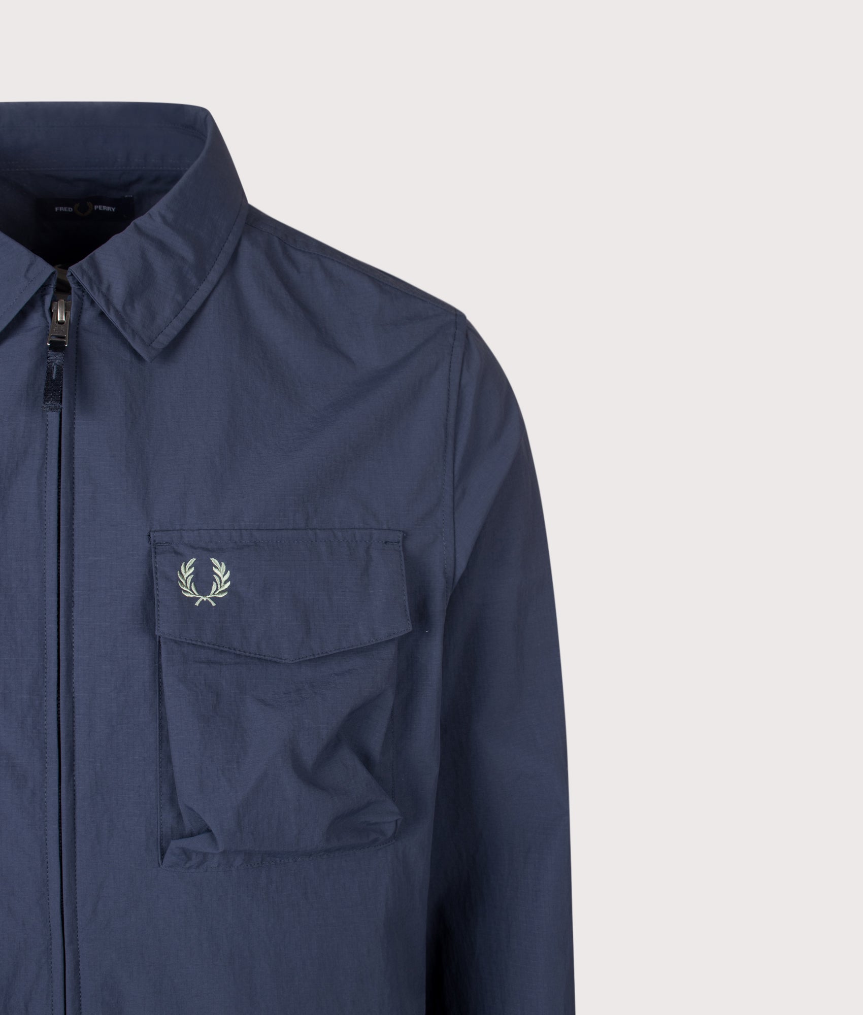 Fred Perry Ripstop Pocket Overshirt in Dark Airforce at EQVVS Menswear. Detail shot.