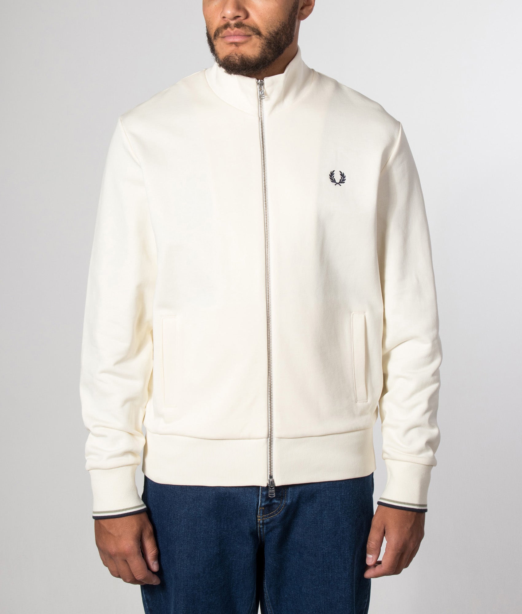 Fred Perry Regular Fit Track Top in Ecru at EQVVS Menswear. Model front shot.
