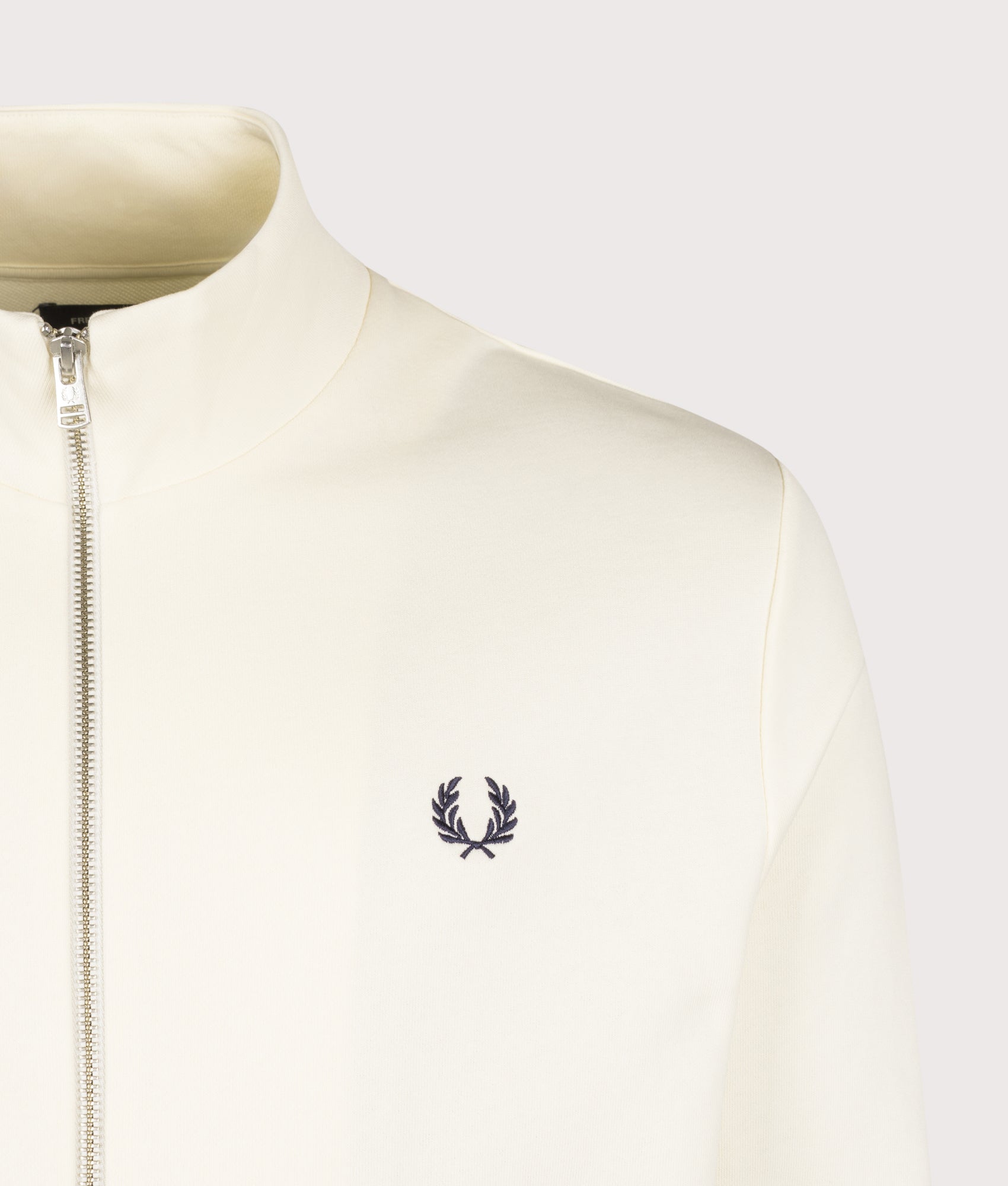 Fred Perry Regular Fit Track Top in Ecru at EQVVS Menswear. Detail shot.