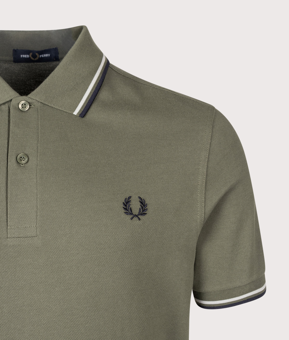 Fred Perry Twin Tipped Polo Shirt in Laurel Wreath Green, Slate and Navy at EQVVS Menswear. Detail shot.