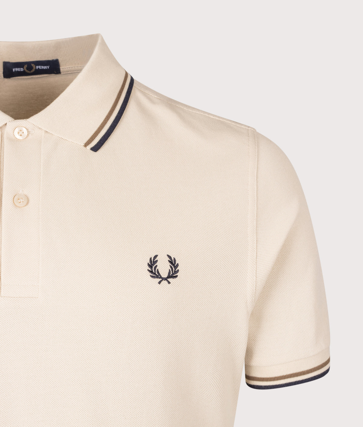 Fred Perry Twin Tipped Polo Shirt in Oatmeal, Bronze and Navy at EQVVS Menswear. Detail shot.