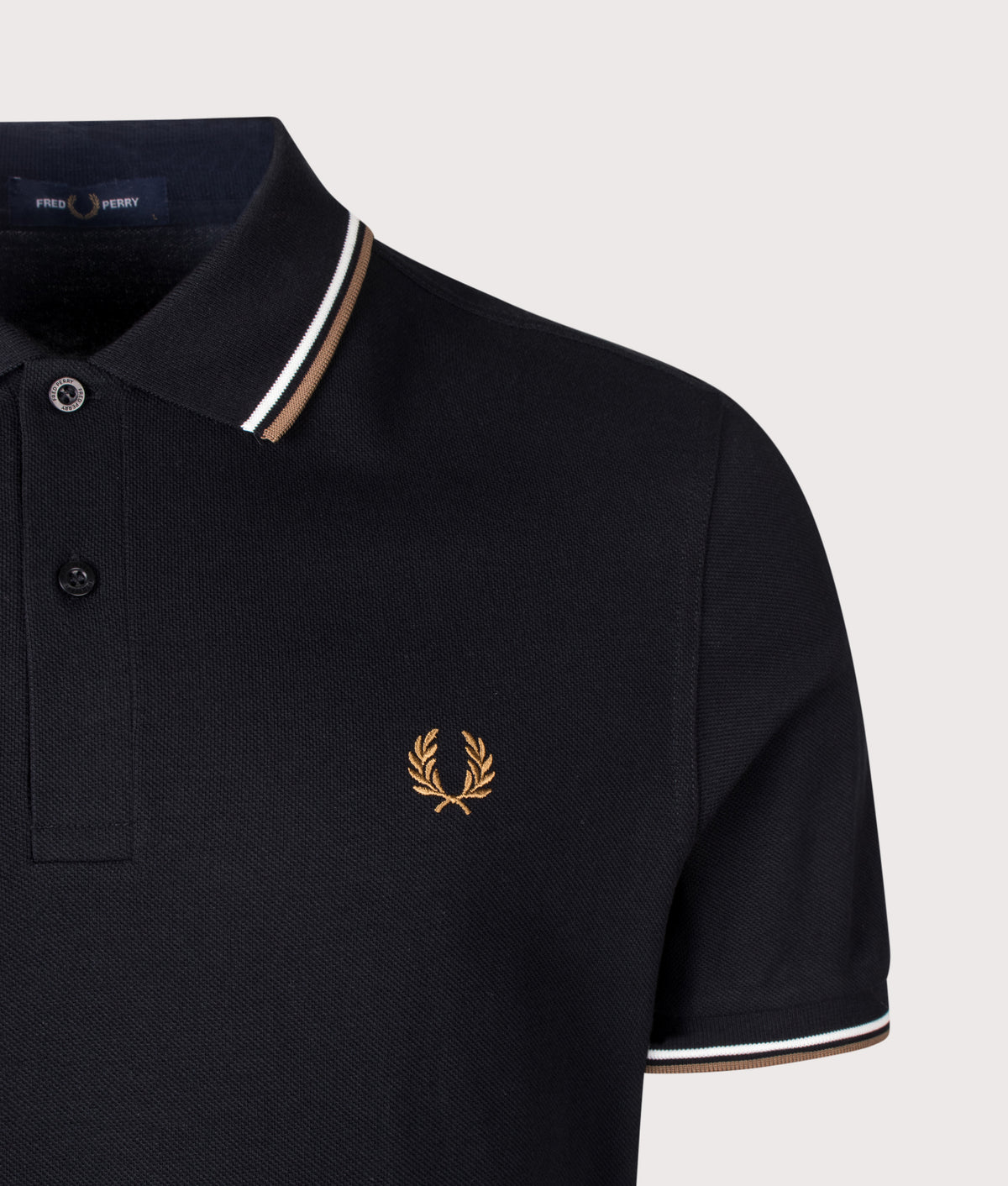 Fred Perry Twin Tipped Polo Shirt in Black, Snow White and Bronze at EQVVS Menswear. Detail shot.