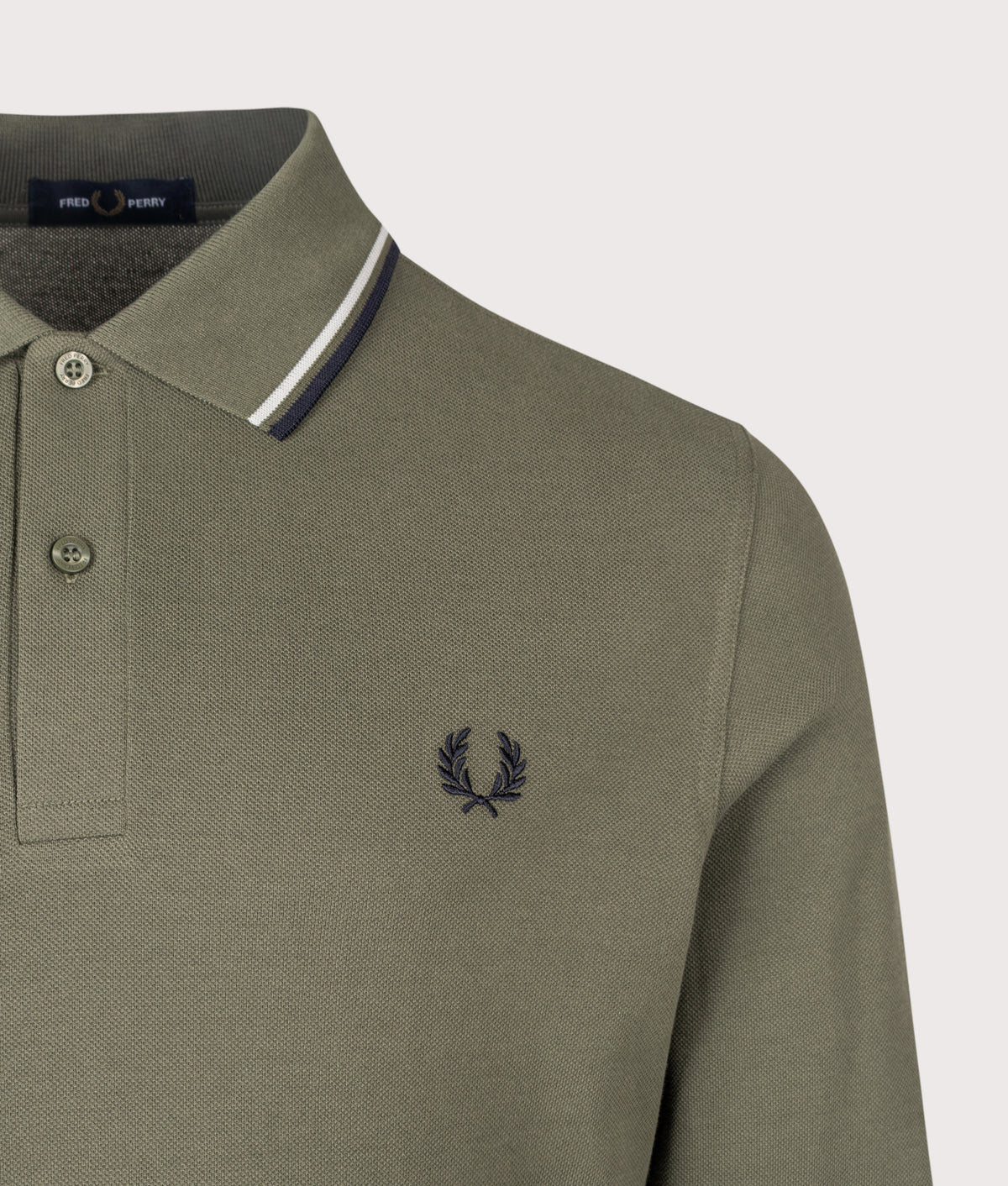 Fred Perry Regular Fit Long Sleeve Twin Tipped Polo Shirt in Laurel Wreath Green, Slate and Navy at EQVVS Menswear. Detail shot.