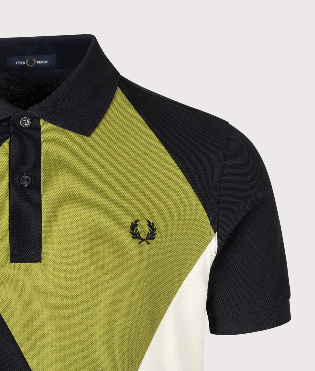 Fred Perry Regular Fit Offset Argyle Cut and Sew Polo Shirt in Black at EQVVS Menswear. Detail shot.