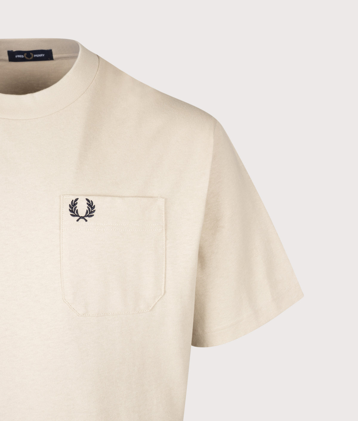Fred Perry Relaxed Fit T-Shirt in Oatmeal at EQVVS Menswear. Detail shot.