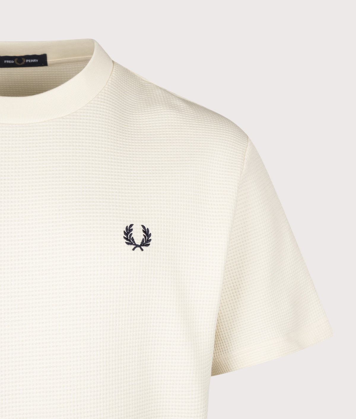 Fred Perry Relaxed Fit Waffle T-Shirt in Ecru at EQVVS Menswear. Detail shot.