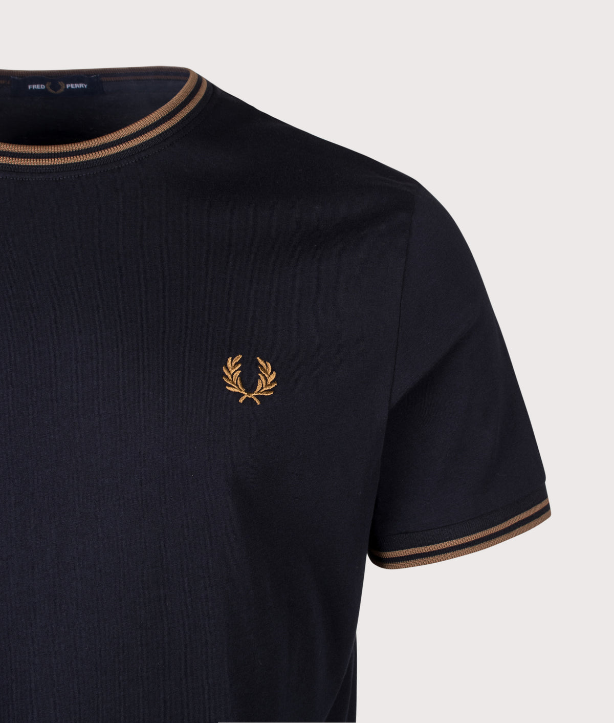 Fred Perry Twin Tipped T-Shirt in Navy and Bronze at EQVVS Menswear. Detail shot.