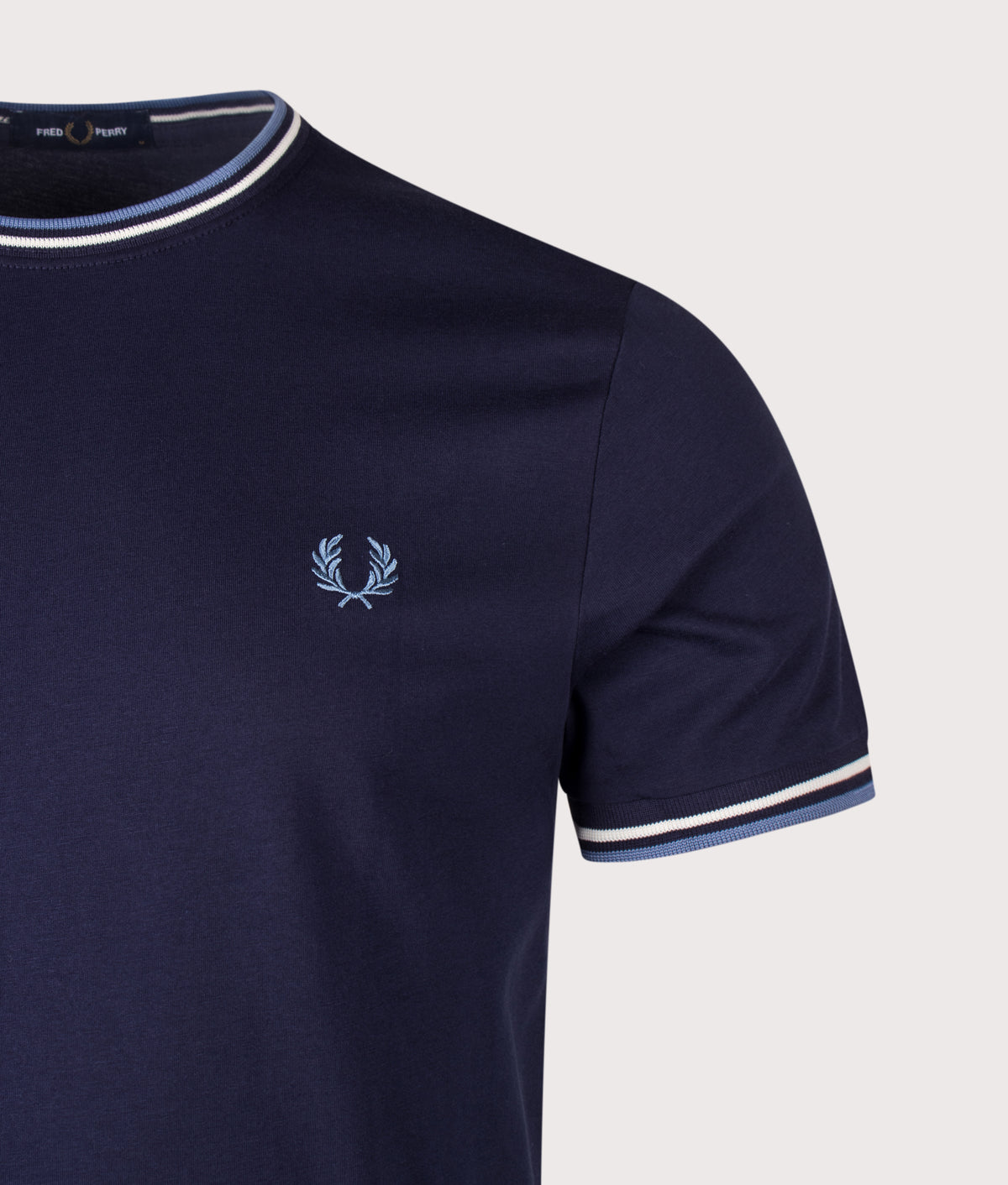 Fred Perry Twin Tipped T-Shirt in Twilight Navy, Ecru and Ace Blue at EQVVS Menswear. Detail shot.