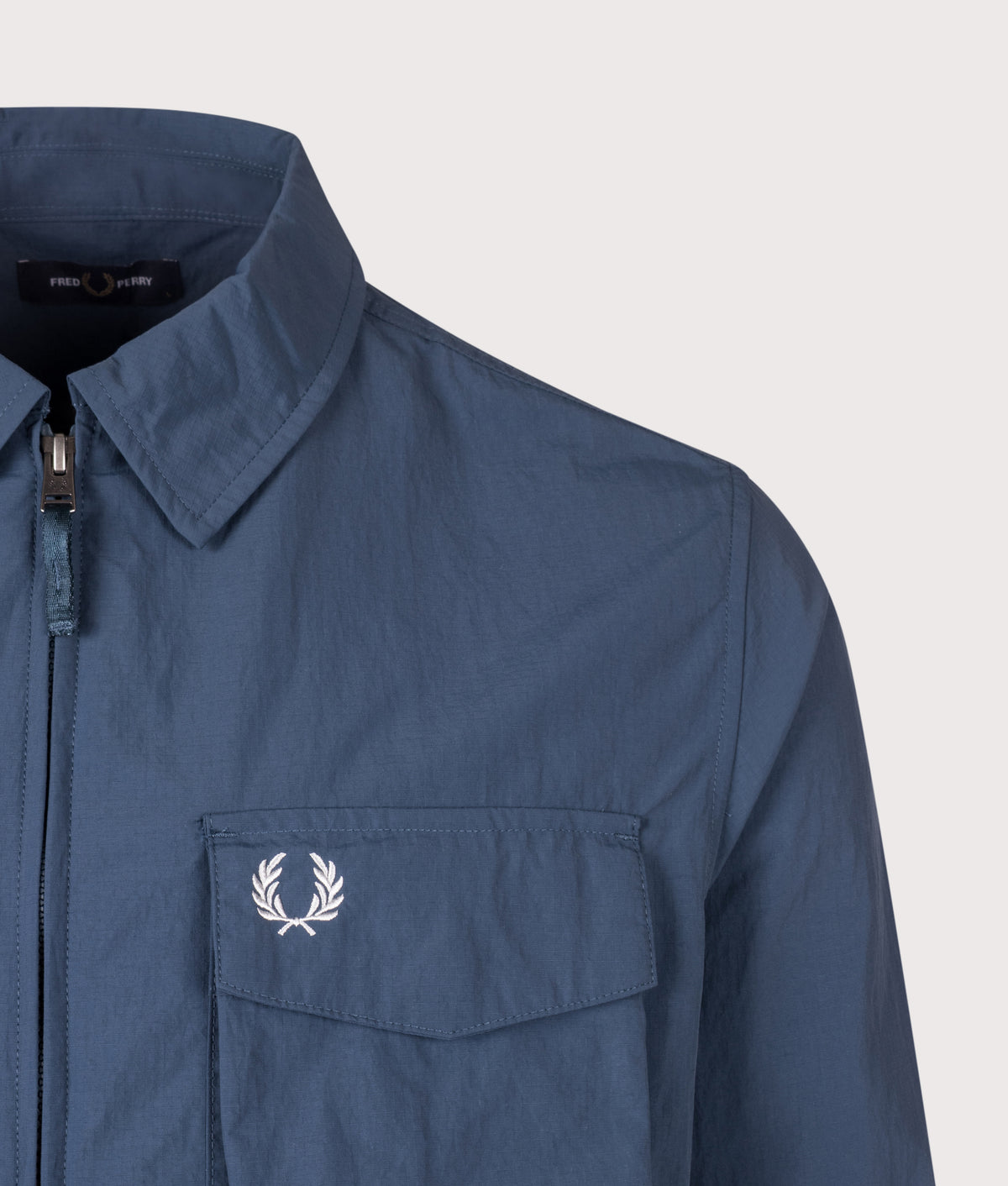 Fred Perry Ripstop Pocket Overshirt in Mod Blue at EQVVS Menswear. Detail shot.