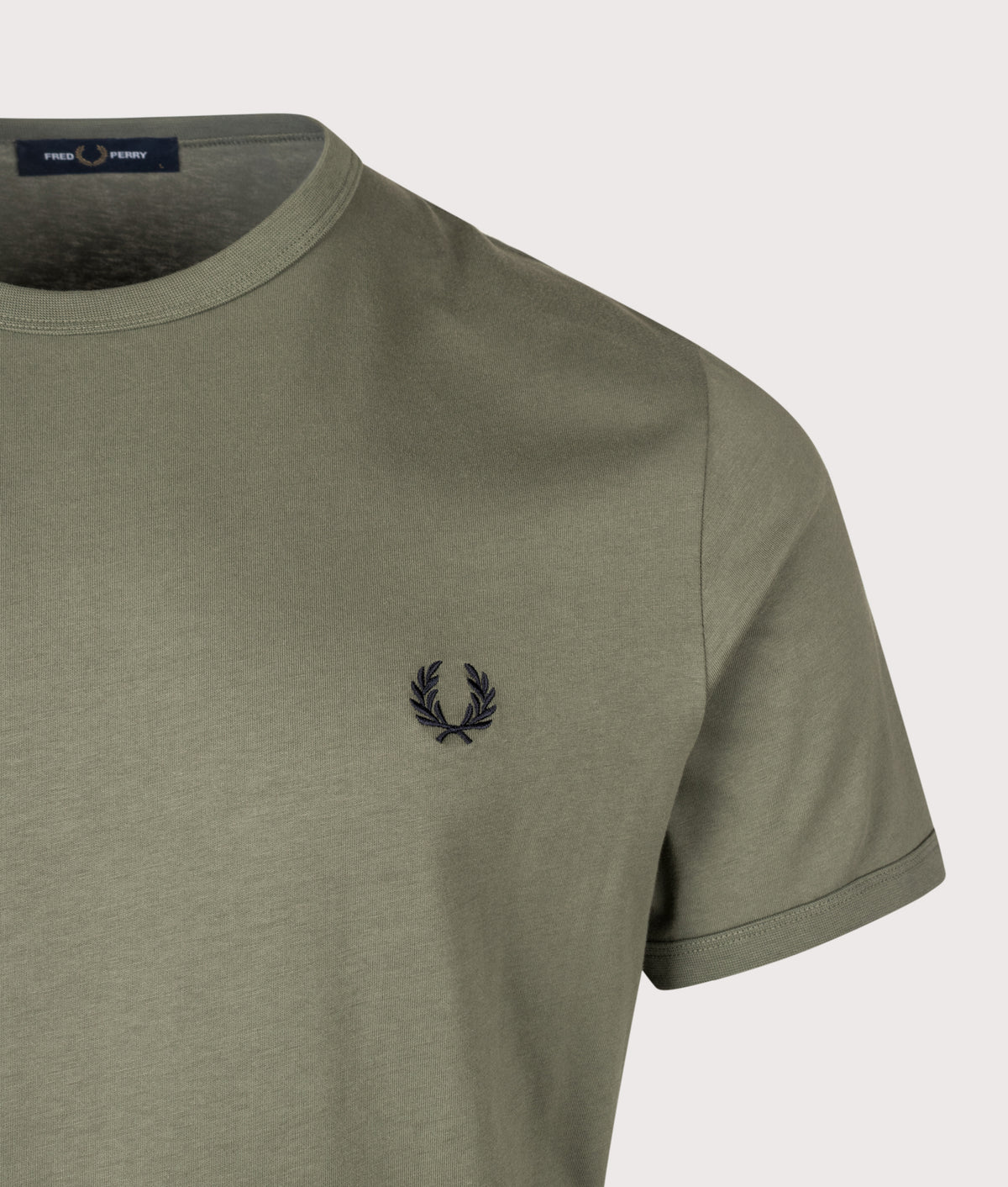 Fred Perry Regular Fit Ringer T-Shirt in Laurel Wreath Green at EQVVS Menswear. Detail shot.
