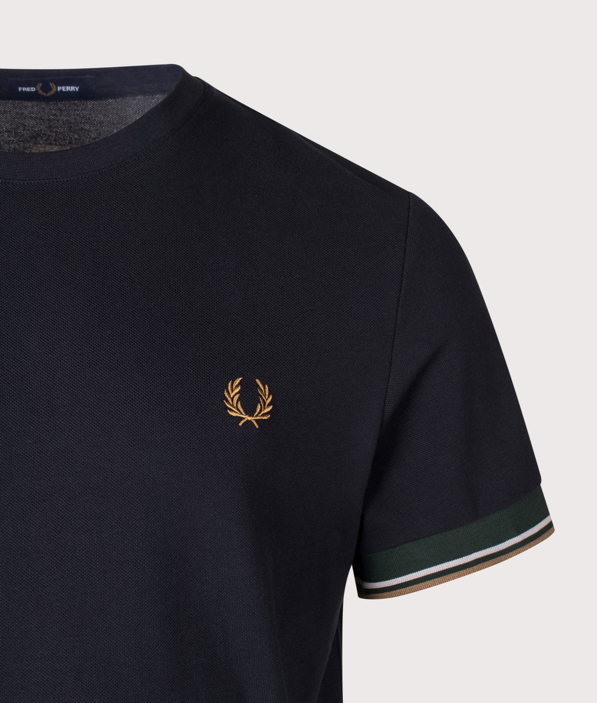Fred Perry Regular Fit Twin Tipped Cuff T-Shirt in Navy at EQVVS Menswear. Detail shot.