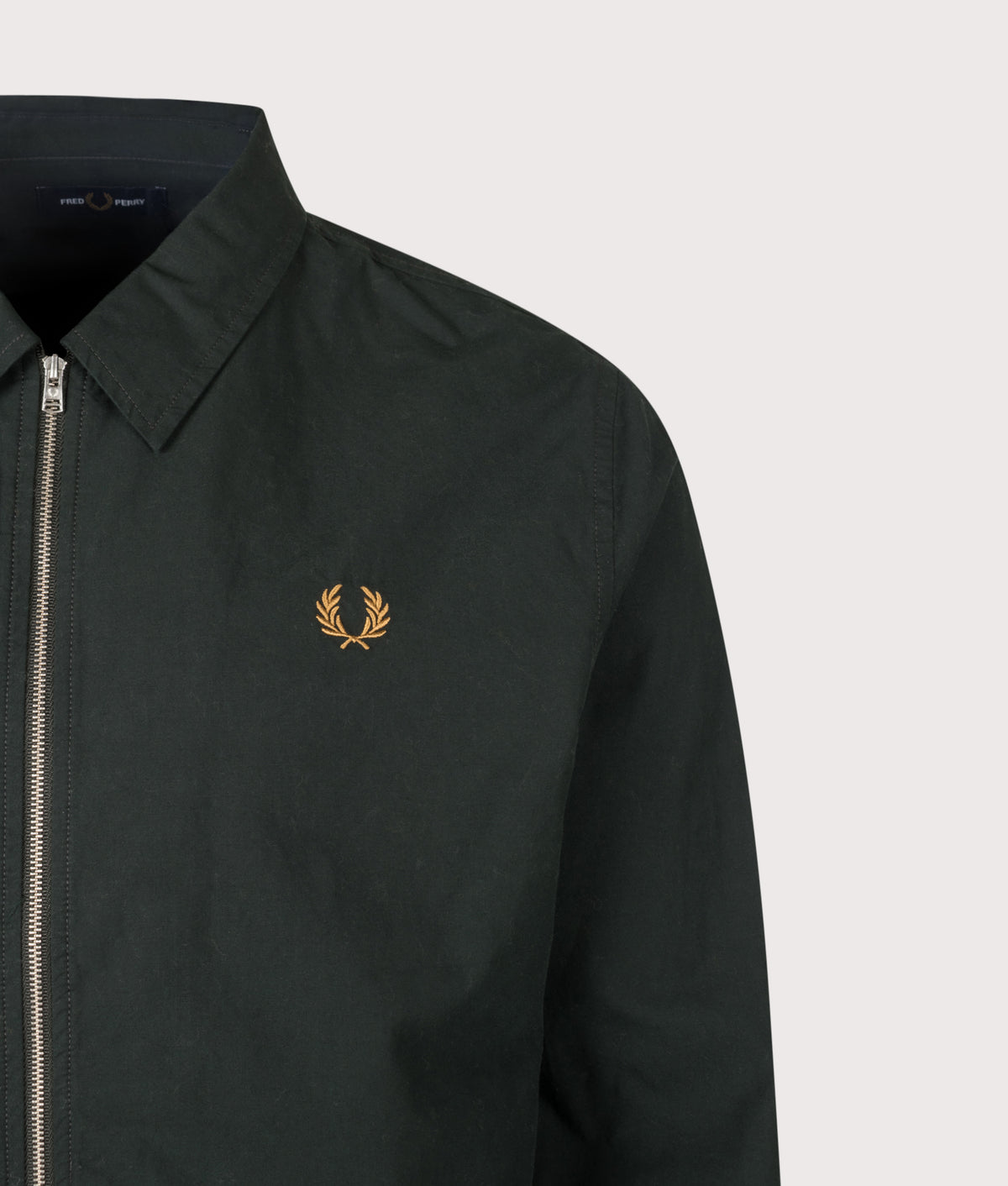 Fred Perry Regular Fit Zip Through Poplin Overshirt in Night Green at EQVVS Menswear. Model front shot.