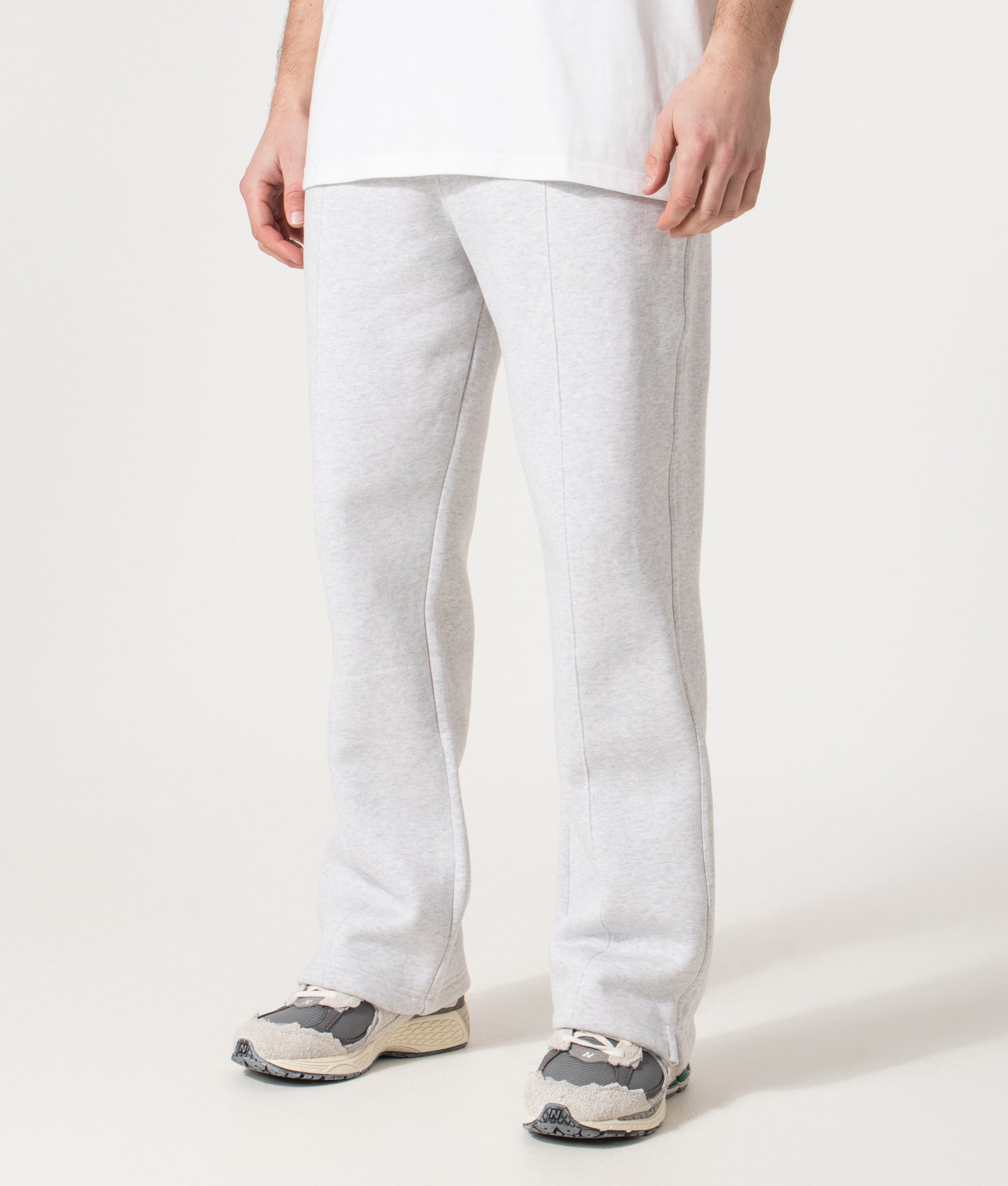 REPRESENT Initial Joggers in Ice Grey Marl at EQVVS Menswear. Angled model front shot. 