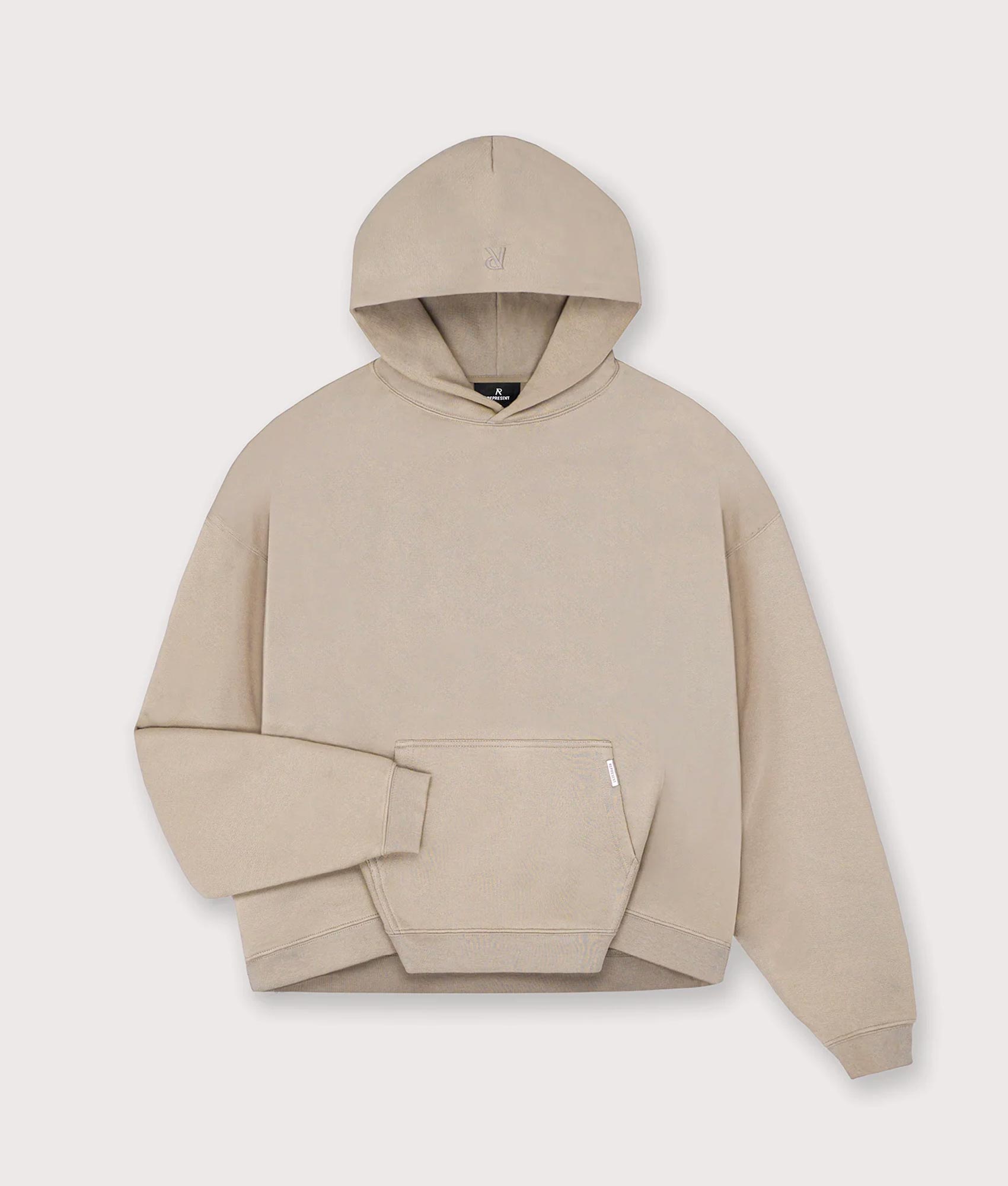 REPRESENT Oversized Initial Boxy Hoodie in Dune at EQVVS Menswear. Front shot.