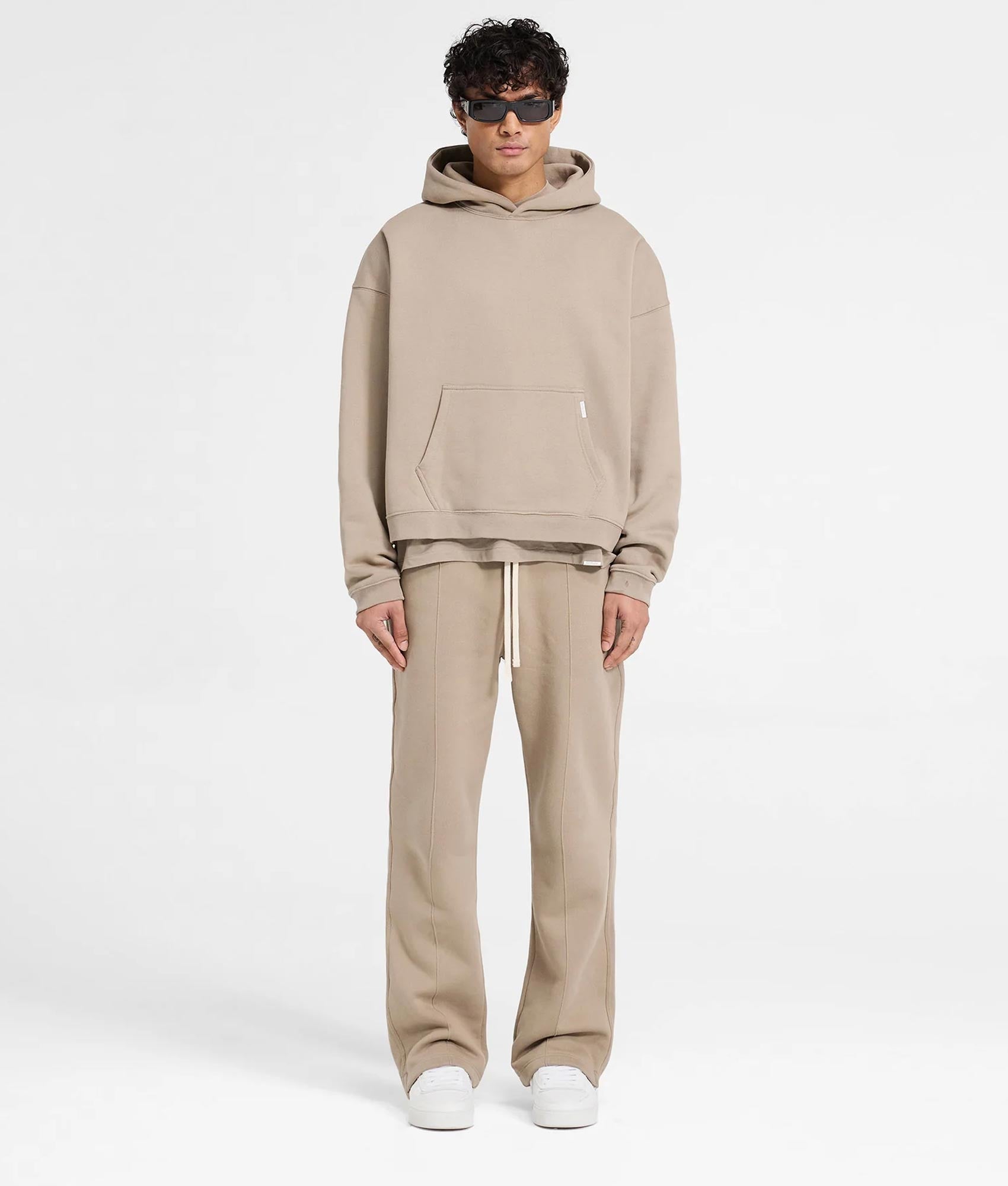 REPRESENT Oversized Initial Boxy Hoodie in Dune at EQVVS Menswear. Model full front shot.