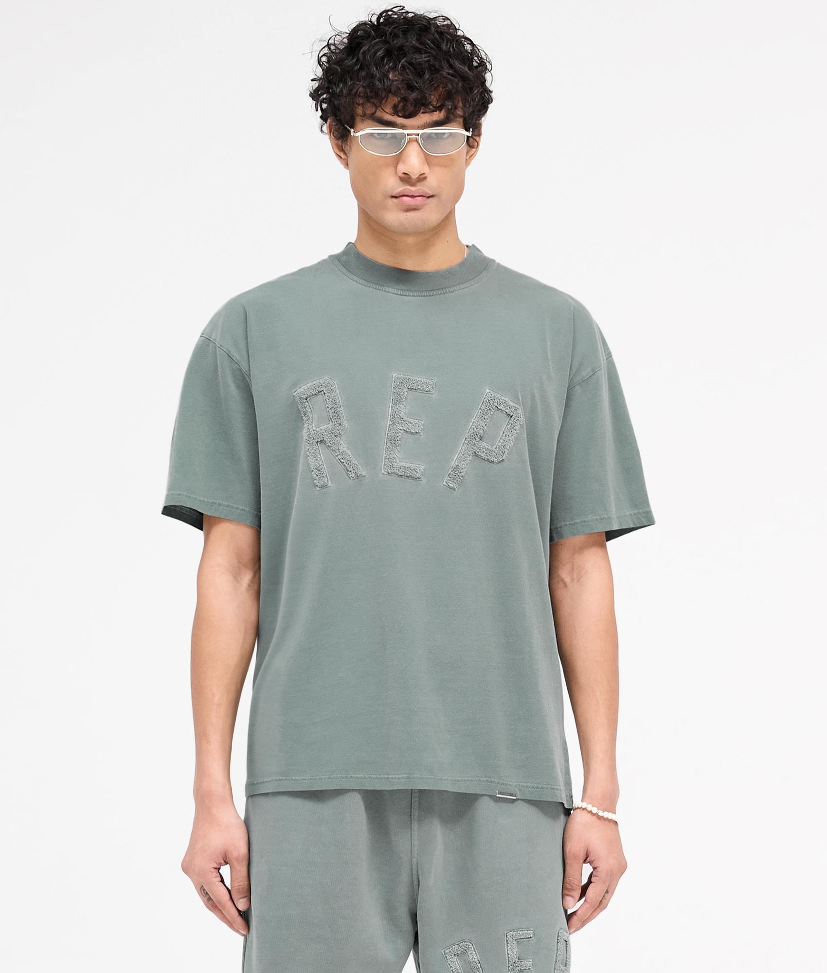 REPRESENT Rep Applique T-Shirt in Forest Green. Shot at EQVVS.  Front shot
