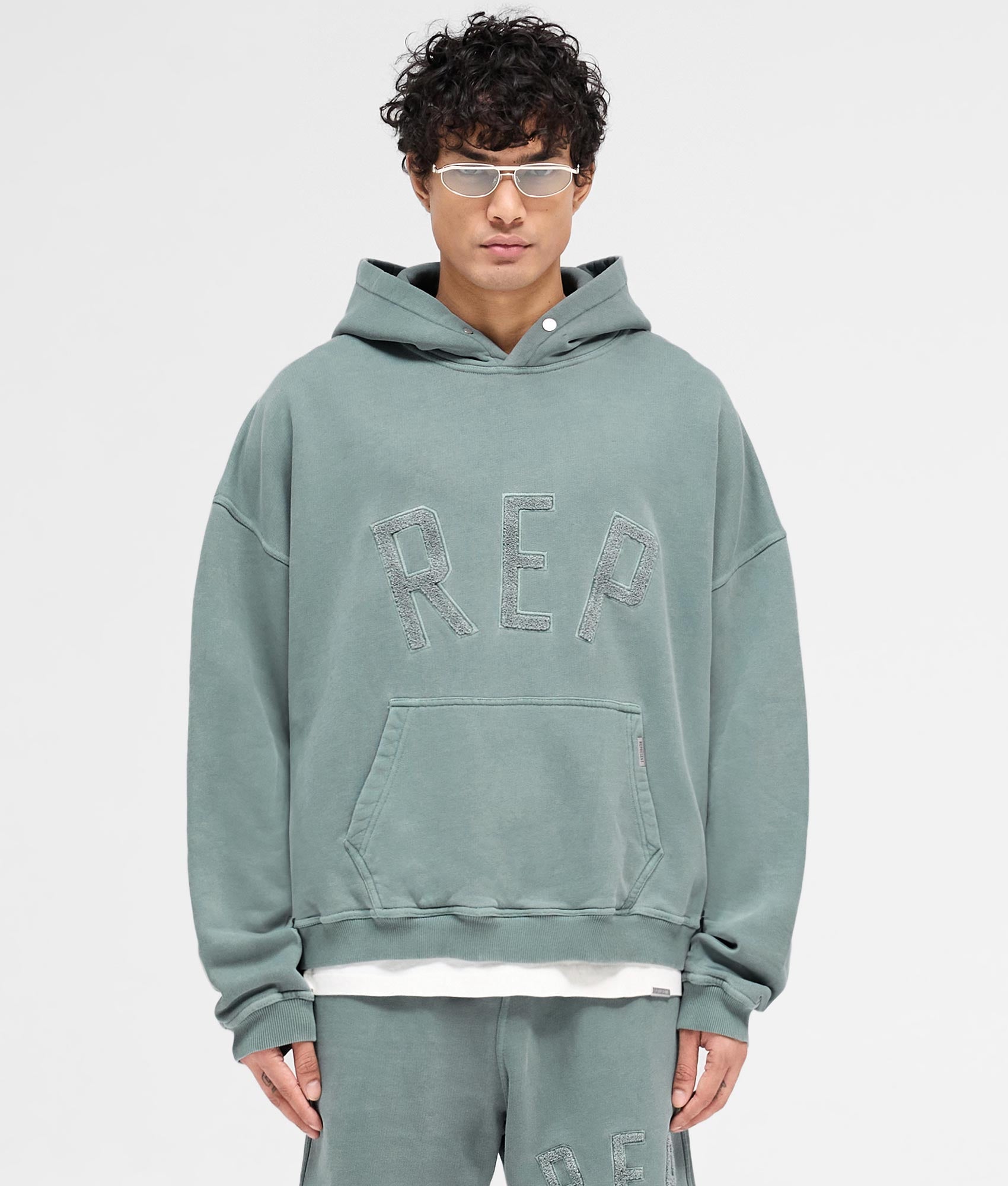REPRESENT Rep Applique Hoodie in Forest Green. Shot at EQVVS. Front shot. 